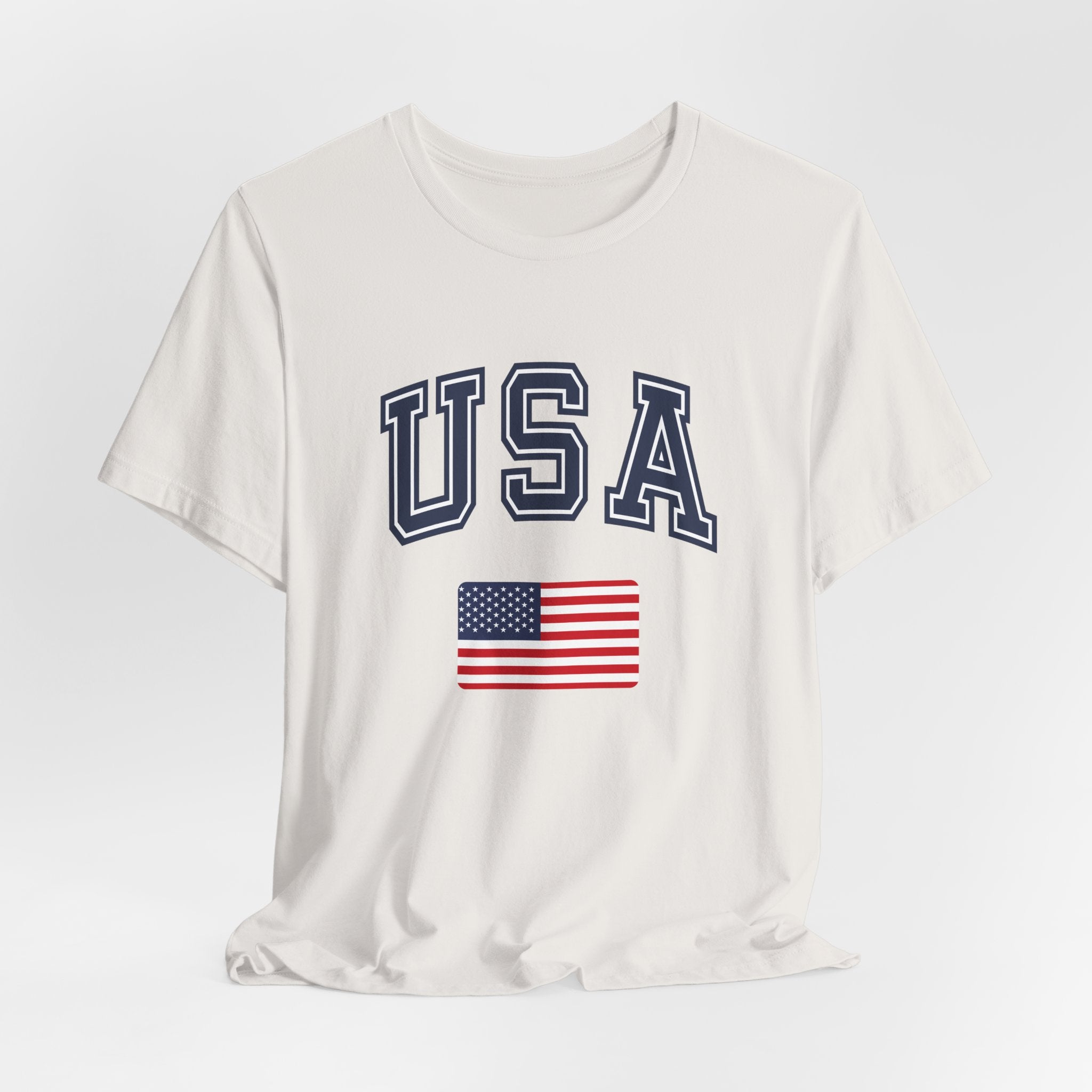 White t-shirt with 'USA' and American flag design on a light gray background