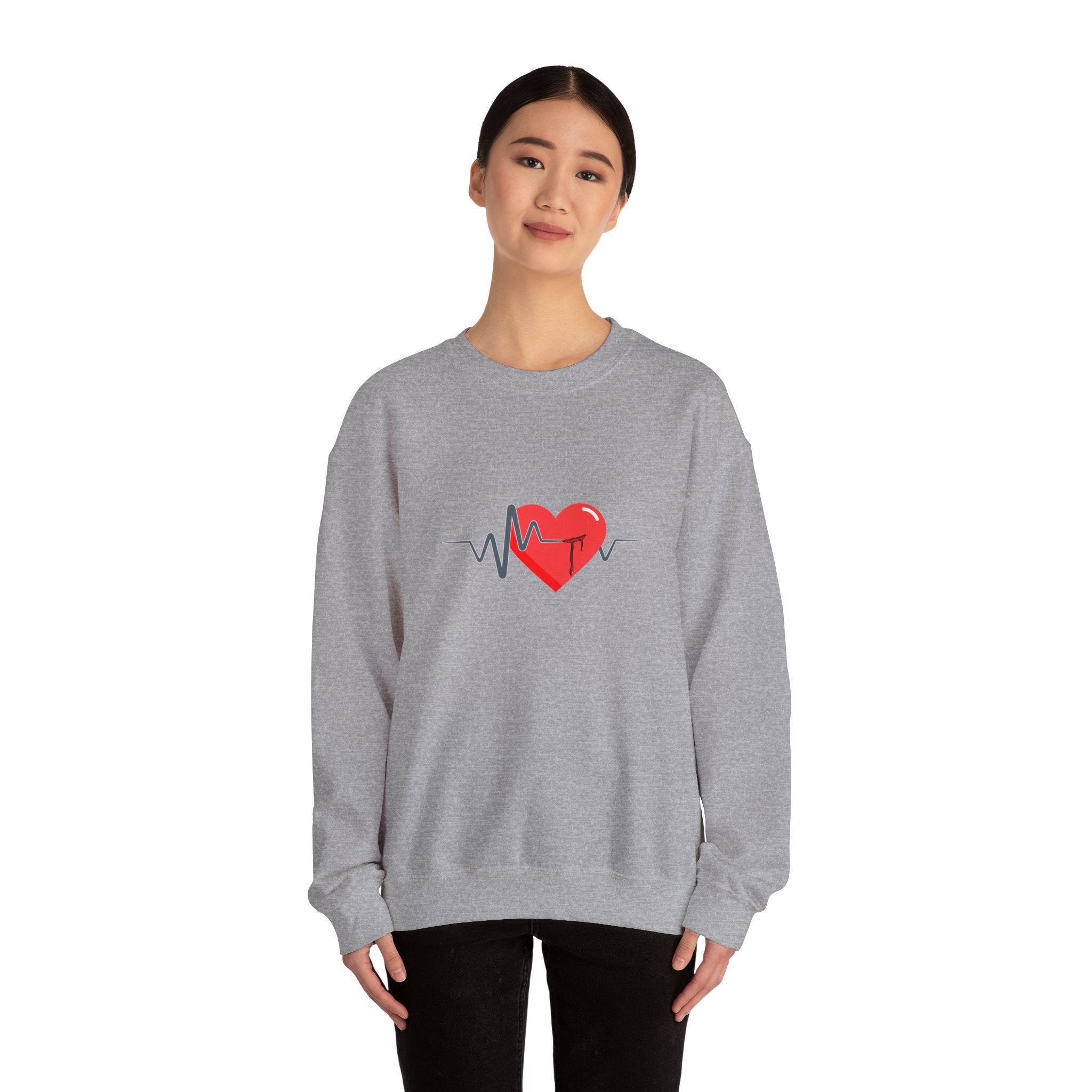 Person wearing a gray sweatshirt with a red heart design on a white background