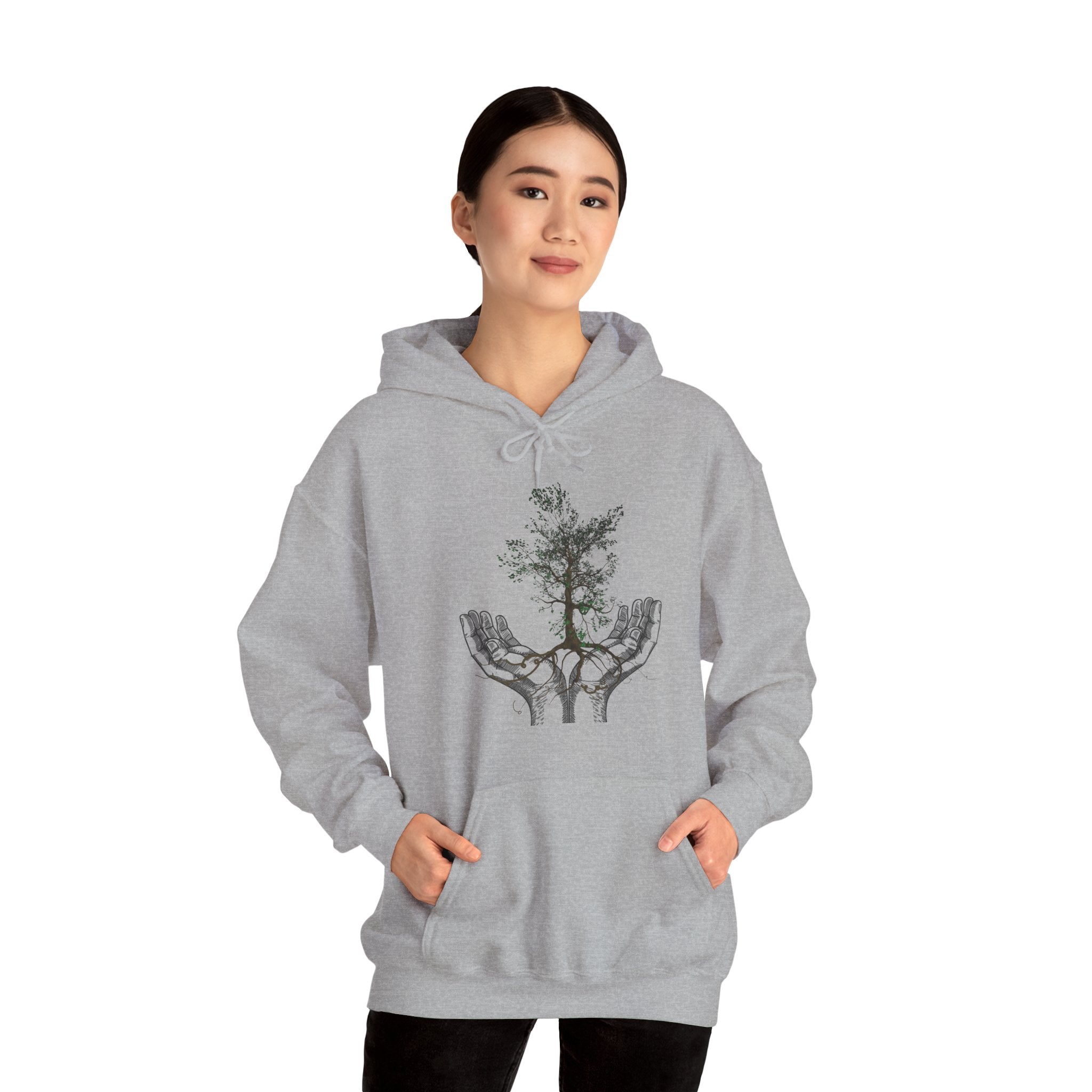 Person wearing a gray hoodie with a tree design on a white background