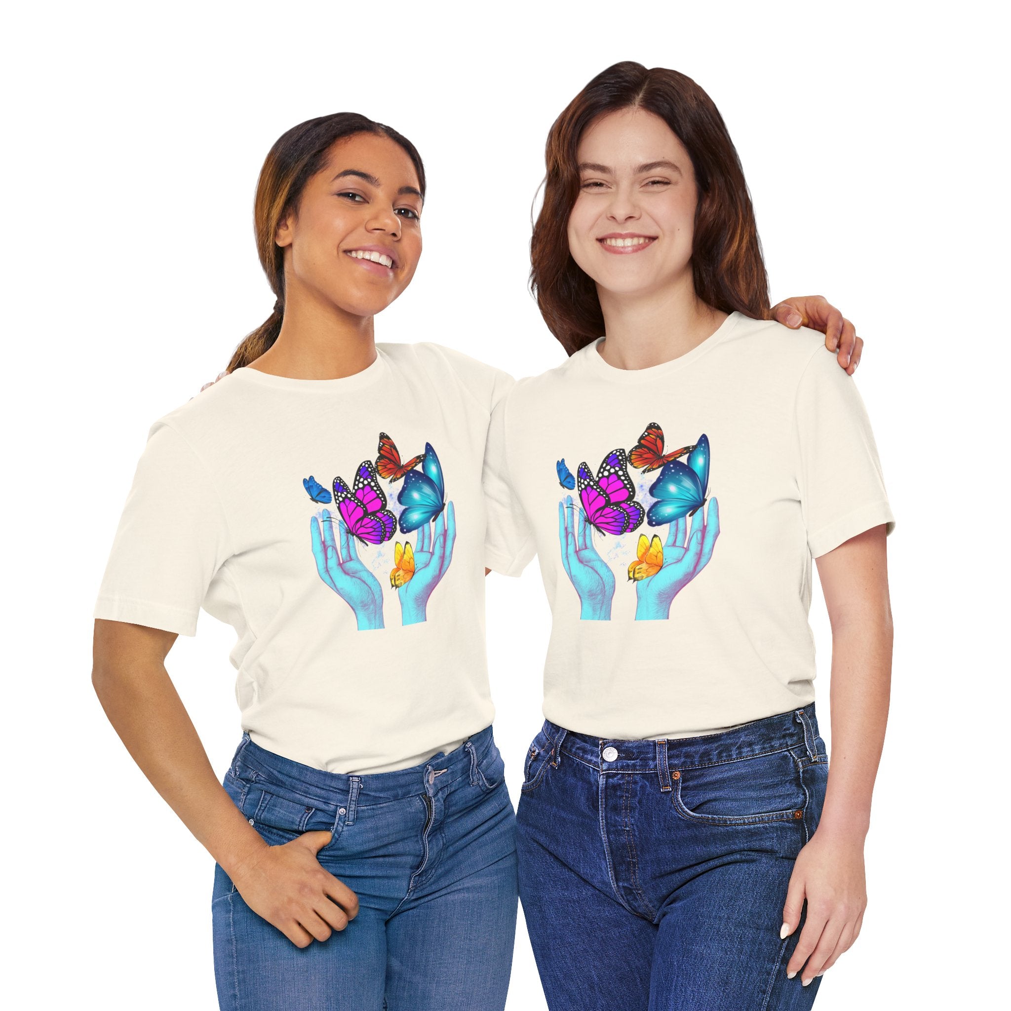 Two women wearing cream t-shirts with colorful butterfly design on a white background