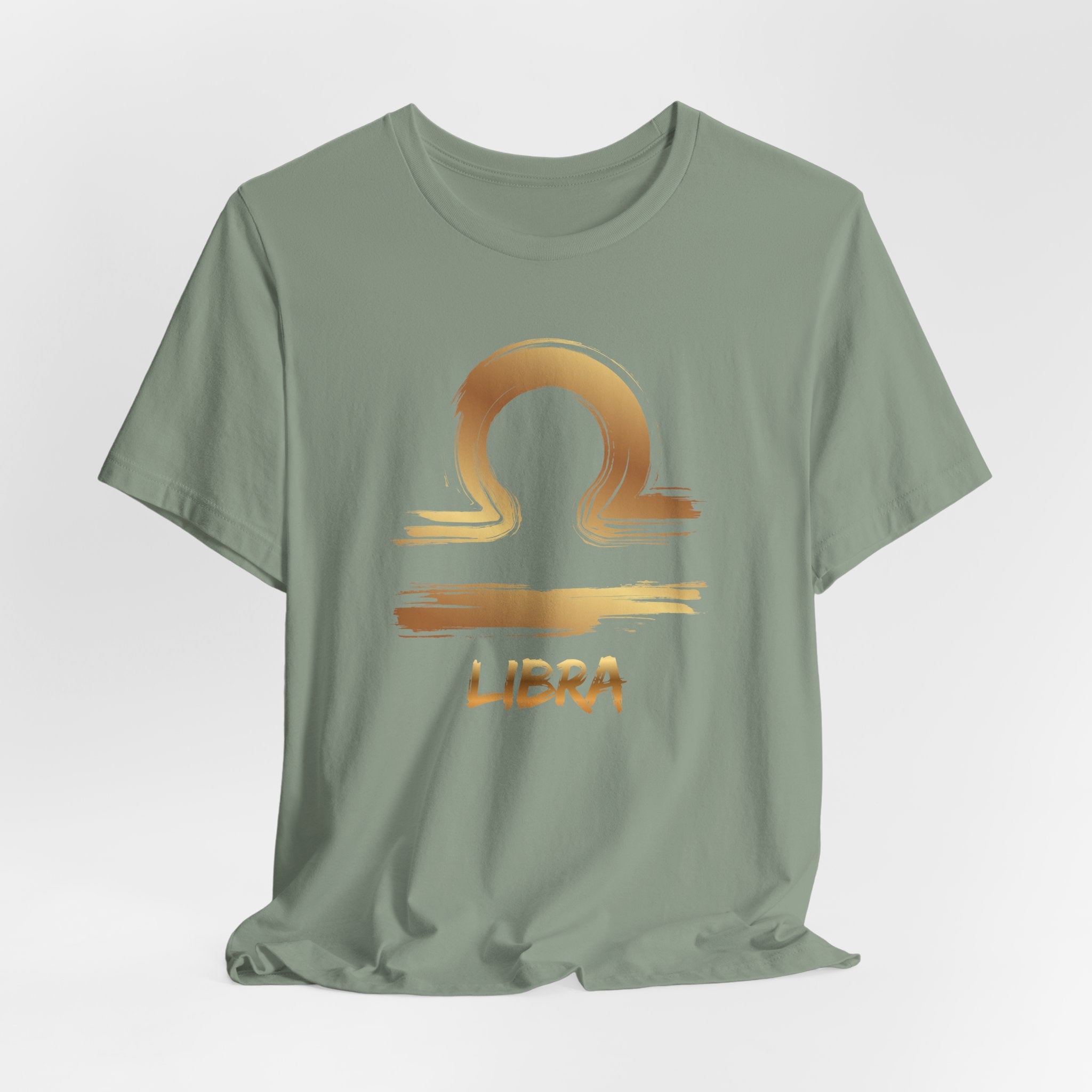 Green t-shirt with Libra zodiac sign design on a light gray background