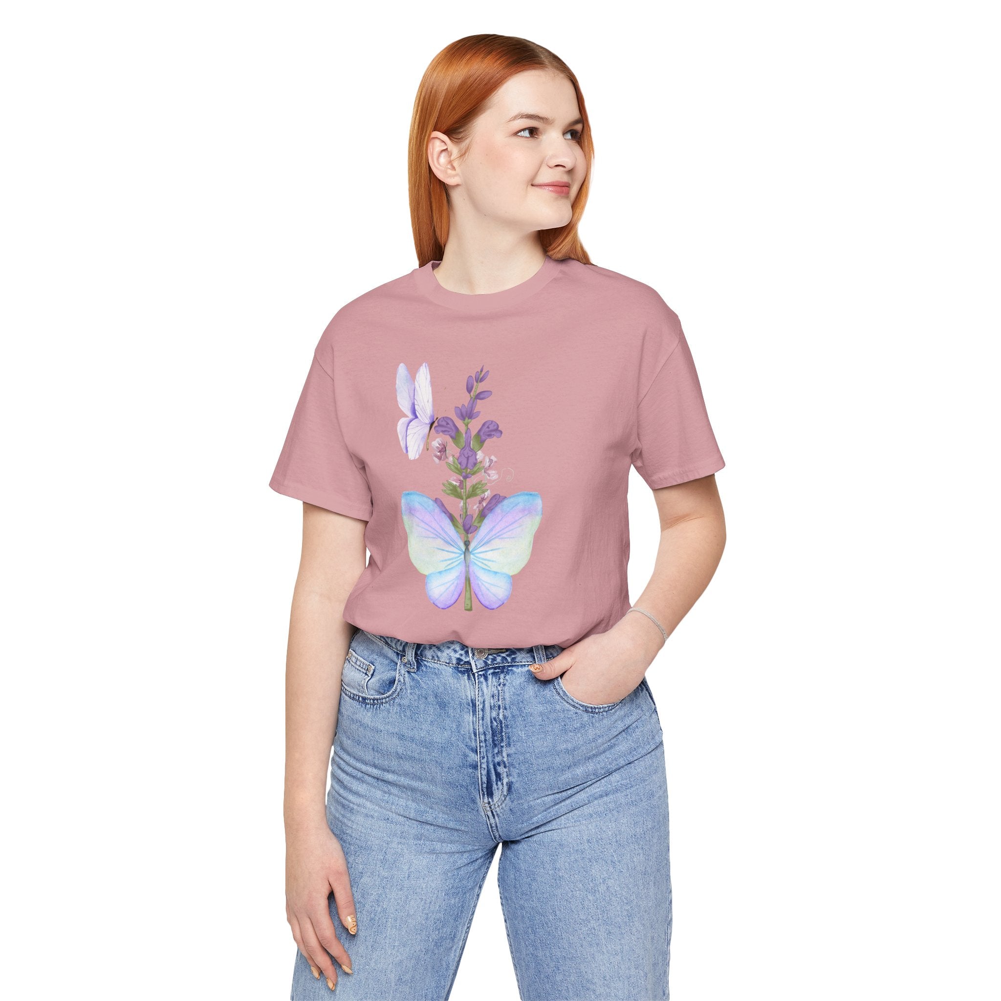Person wearing a pink t-shirt with butterfly design on a white background
