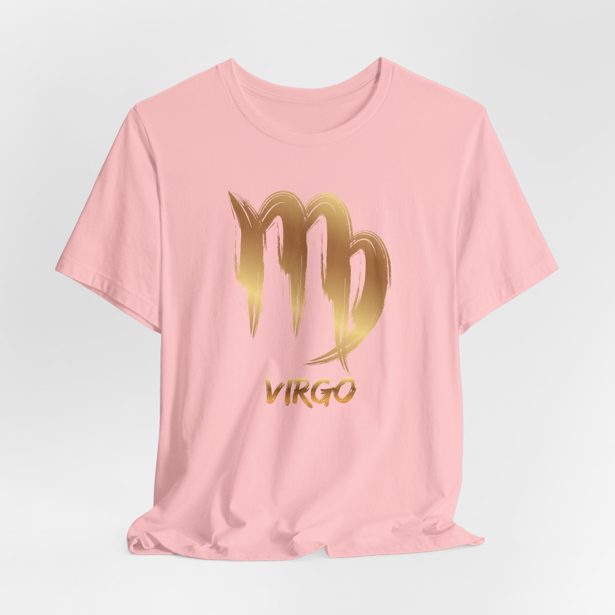 Pink t-shirt with gold Virgo zodiac sign design on a light gray background