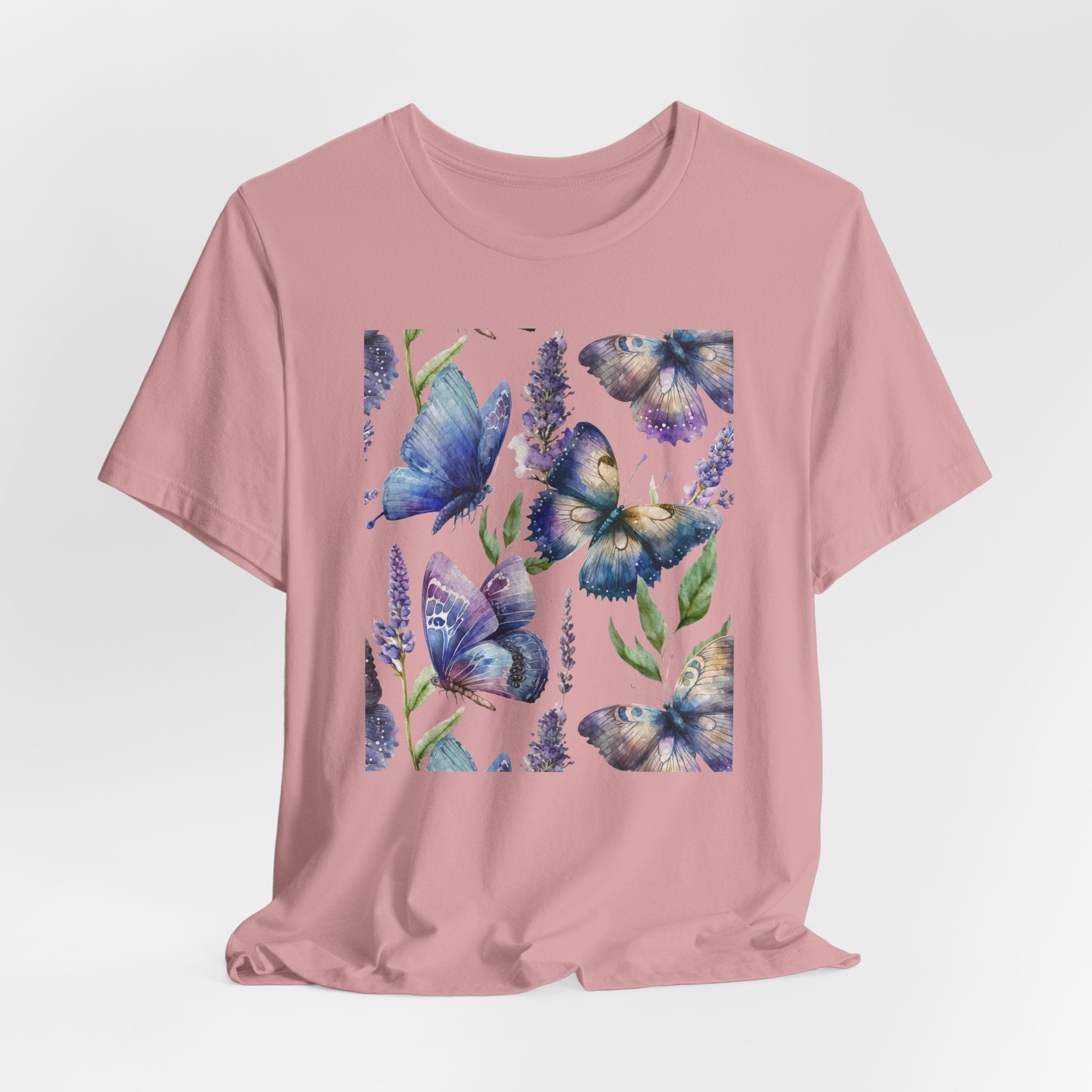 Pink t-shirt with blue butterfly design on a light gray background