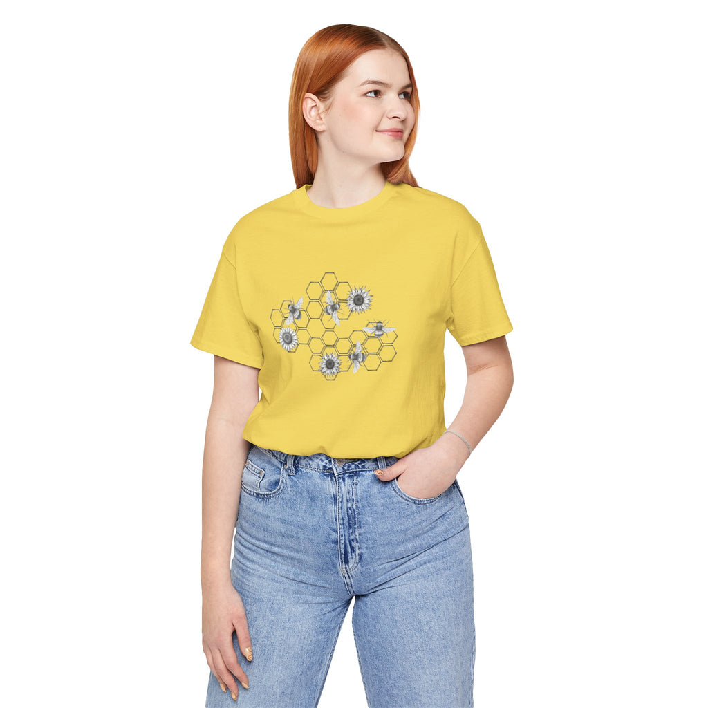 Person wearing a yellow t-shirt with a floral design and blue jeans on a white background
