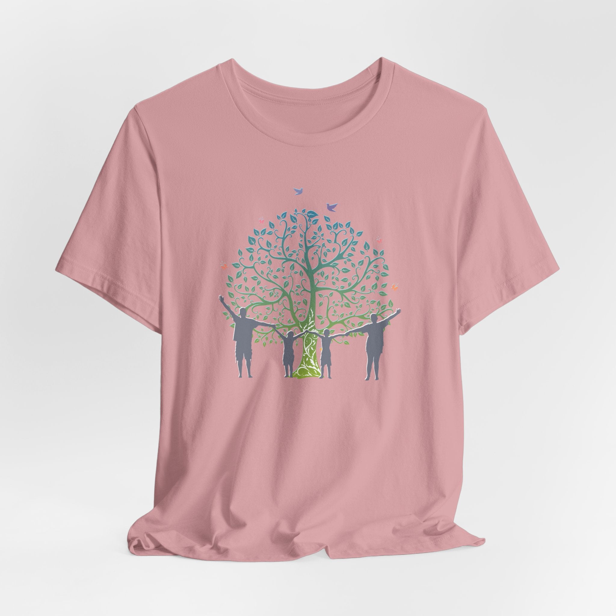 Pink t-shirt with a graphic of people around a tree on a white background