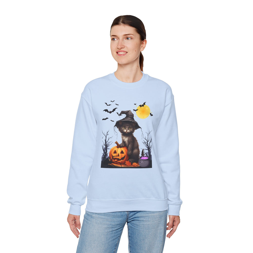 Woman wearing a light blue sweatshirt with a Halloween-themed design featuring a cat, pumpkins, and bats.