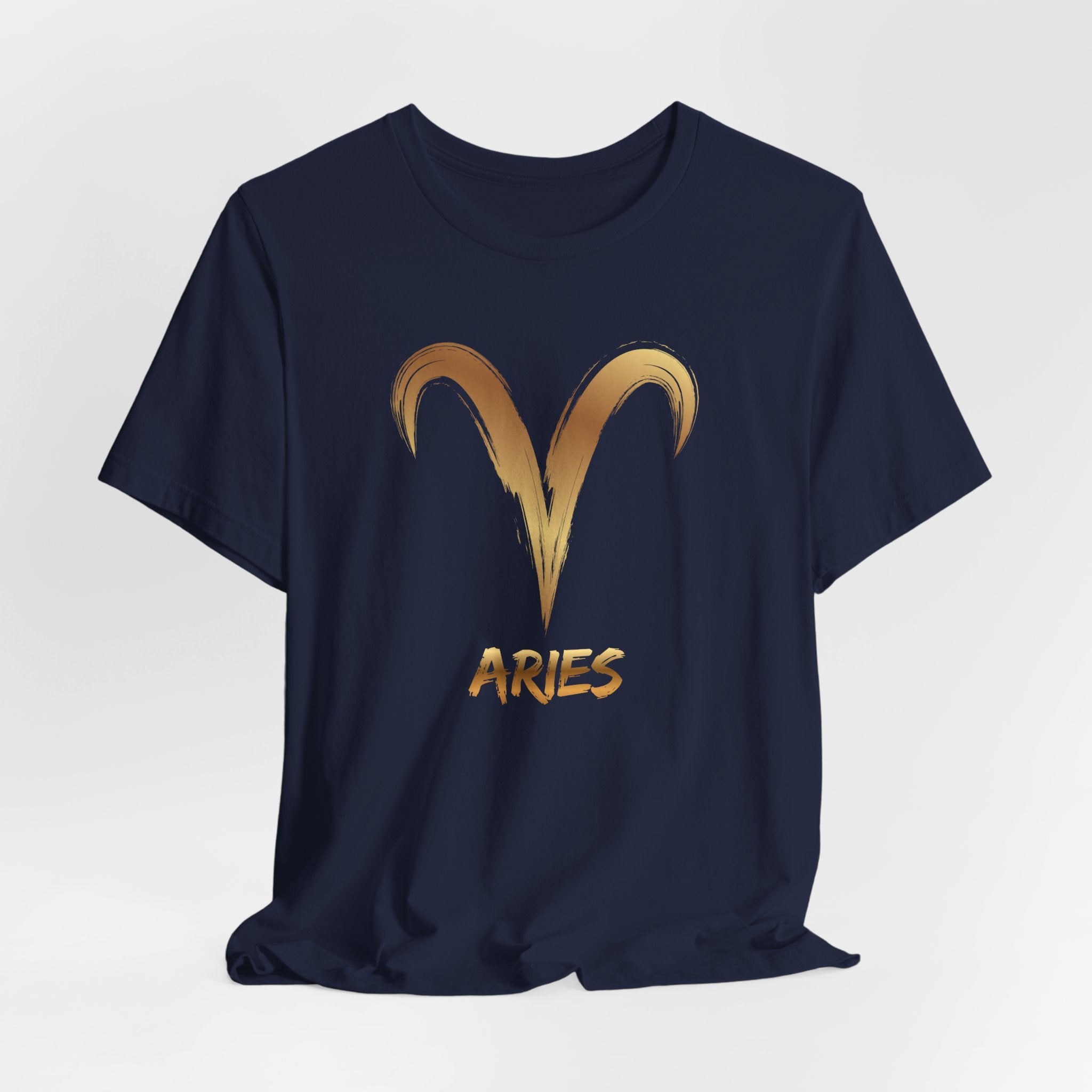 Navy blue t-shirt with gold Aries symbol and text on a light gray background