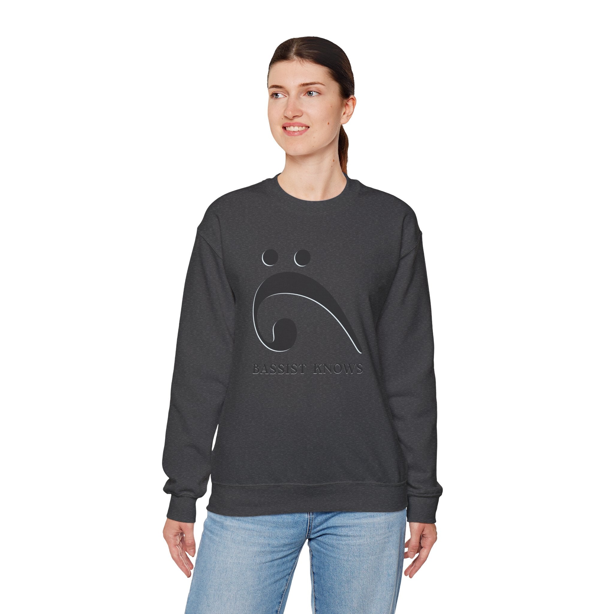 Person wearing a dark gray sweatshirt with a black bass clef graphic and "Bassist Knows" text on a white background