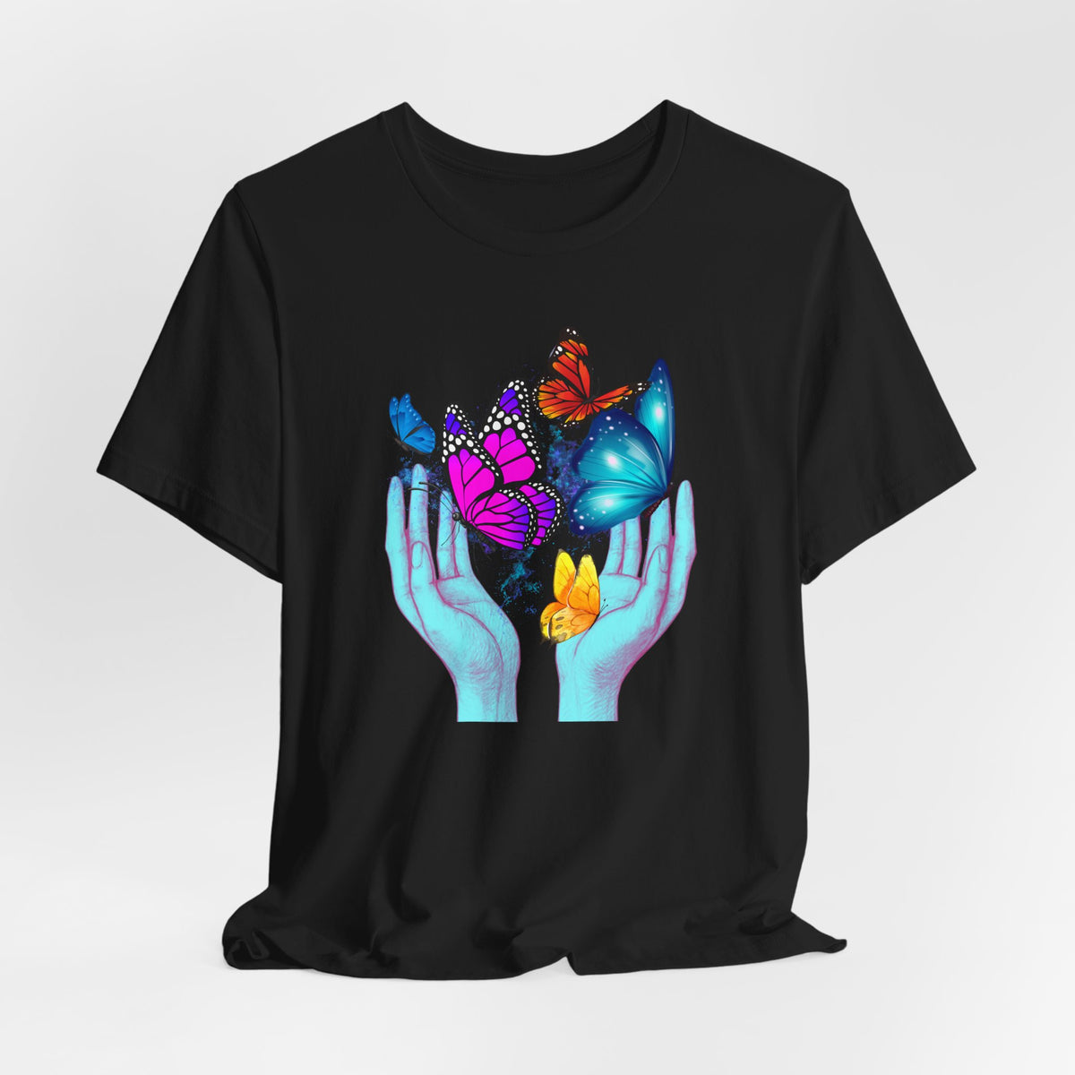 Black t-shirt with colorful butterfly design on a white background