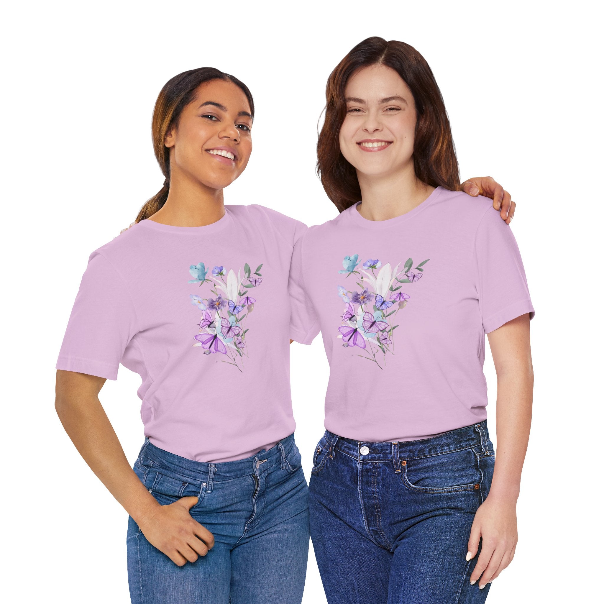 Two women wearing matching purple t-shirts with floral designs on a white background