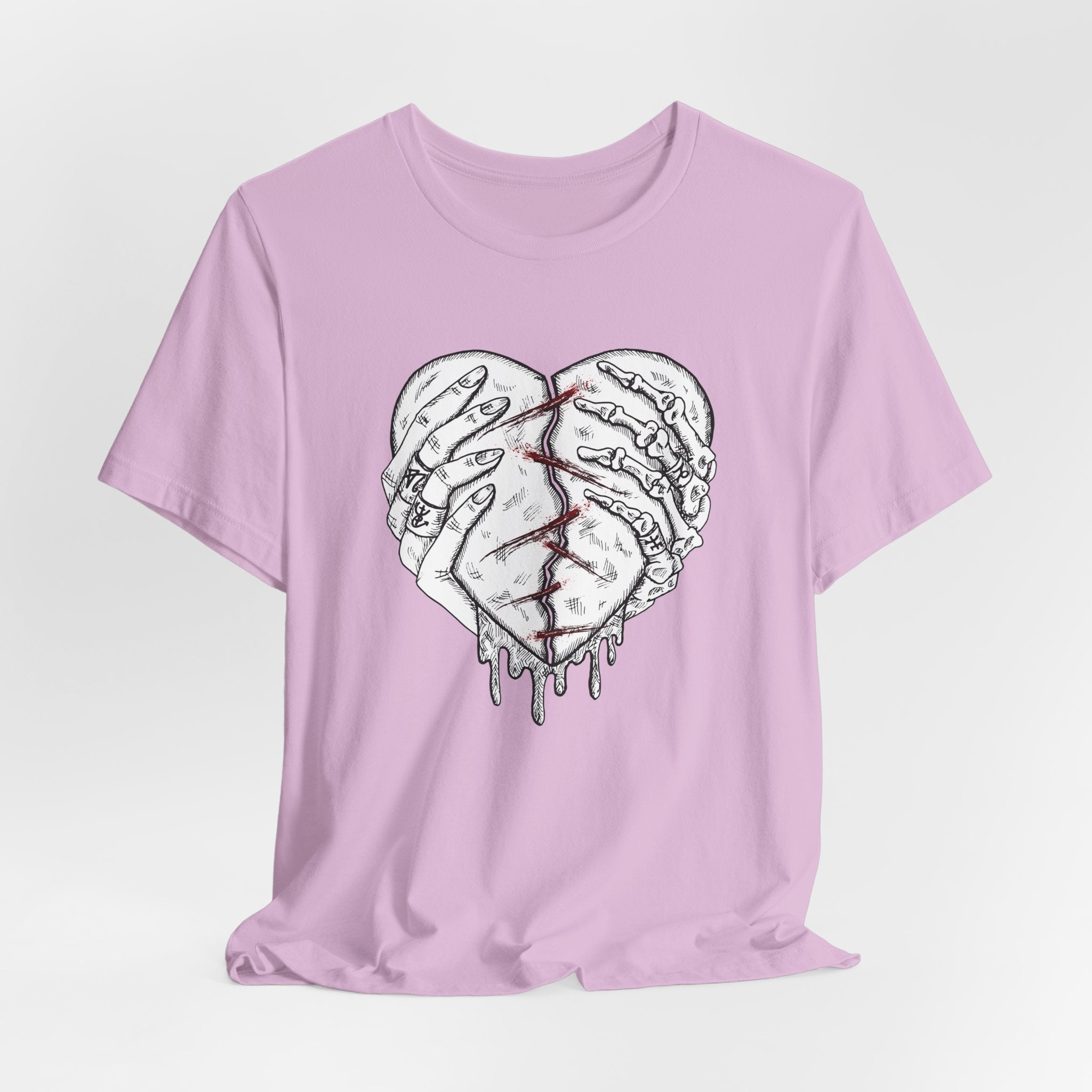 Pink t-shirt with a graphic of a broken heart design on a white background