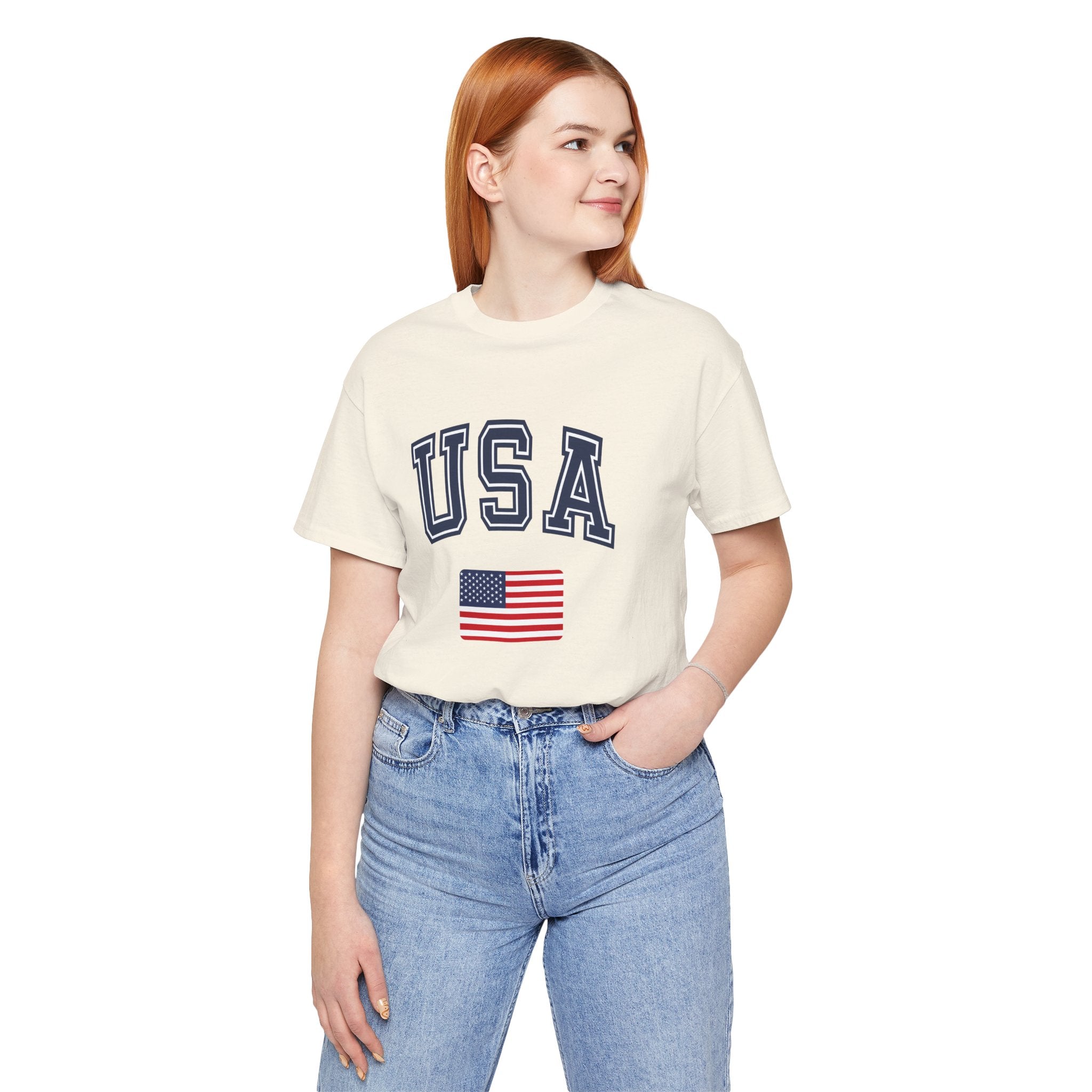 Person wearing a cream t-shirt with 'USA' and an American flag design on a white background