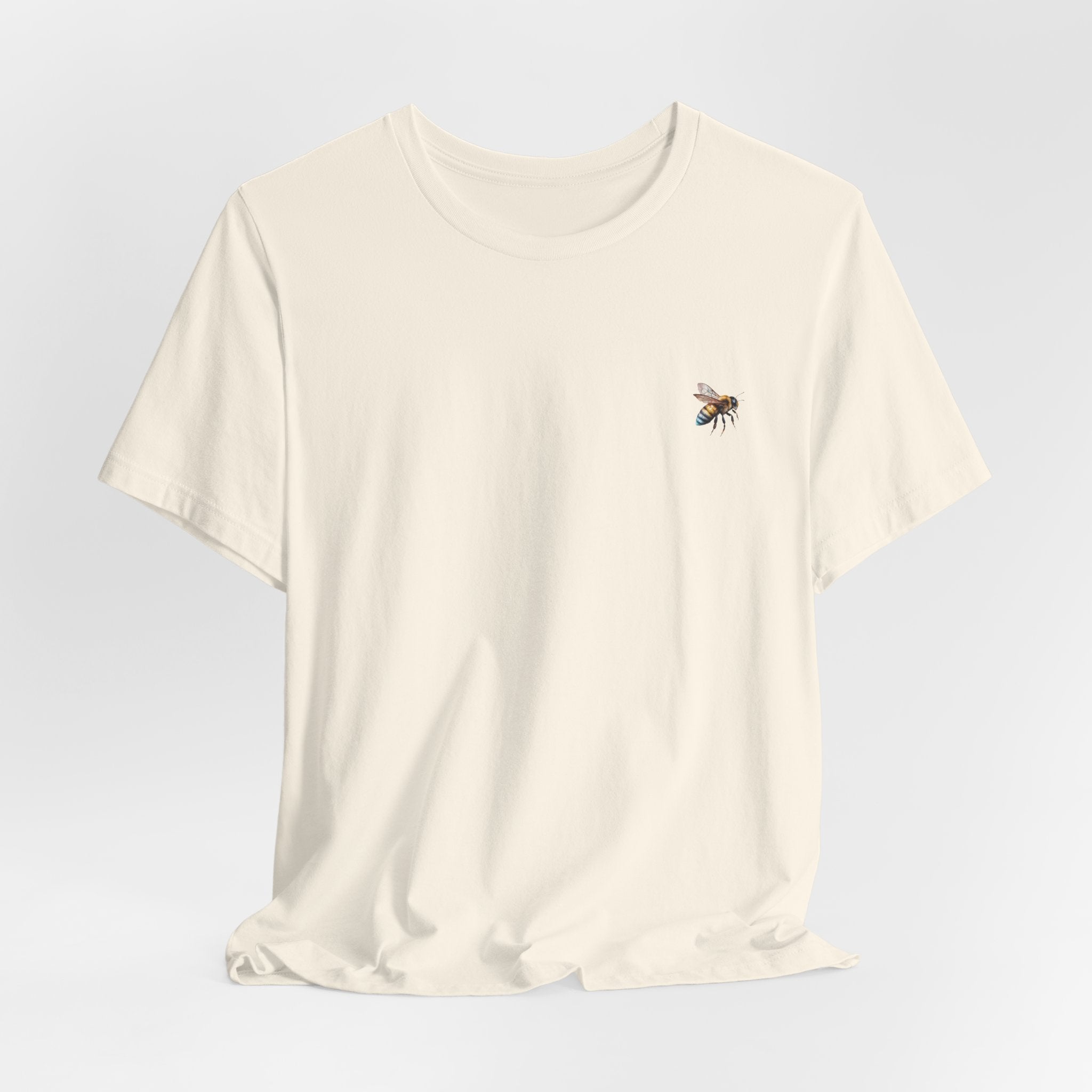 Beige t-shirt with a bee design on a light gray background