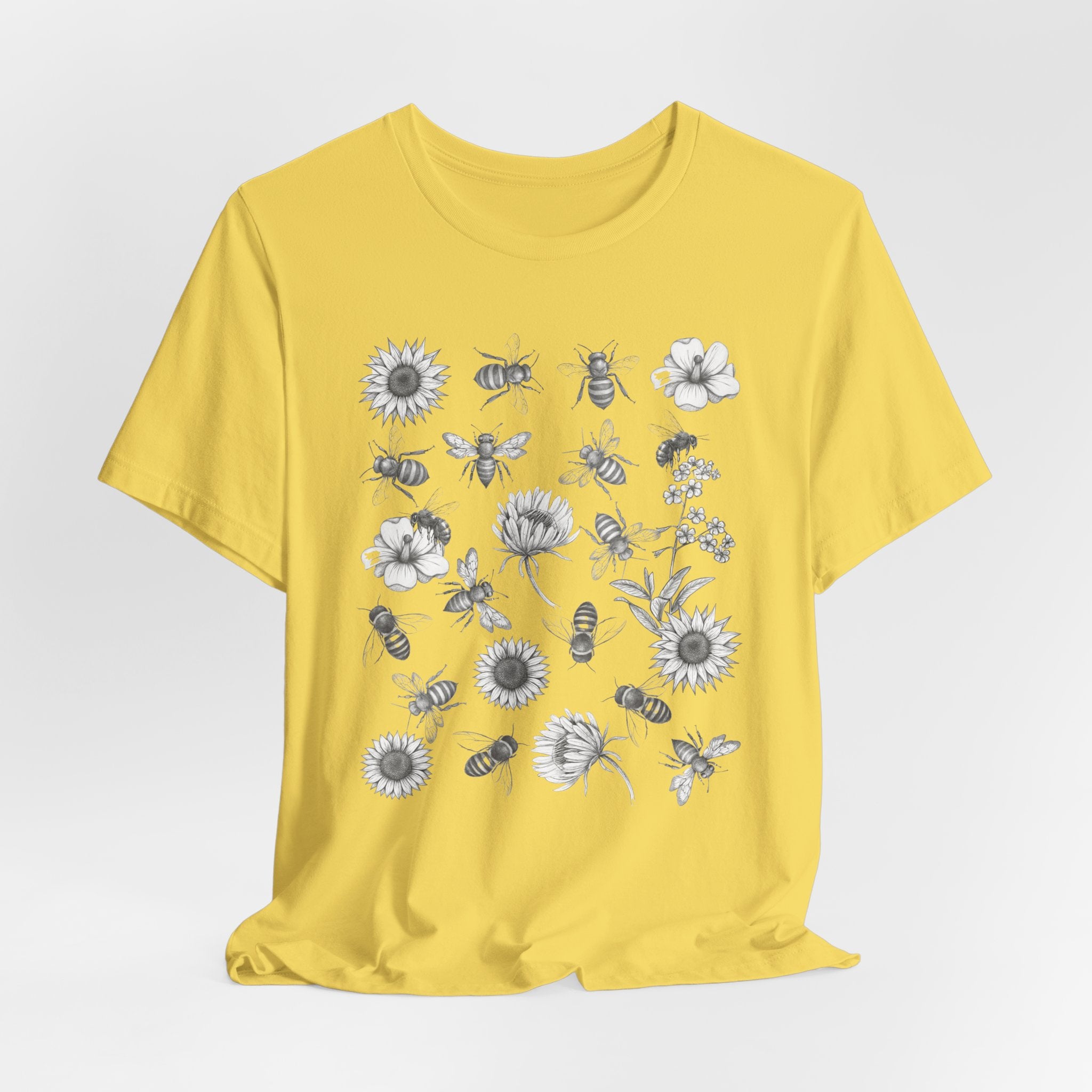 Yellow t-shirt with bee and flower pattern on a white background