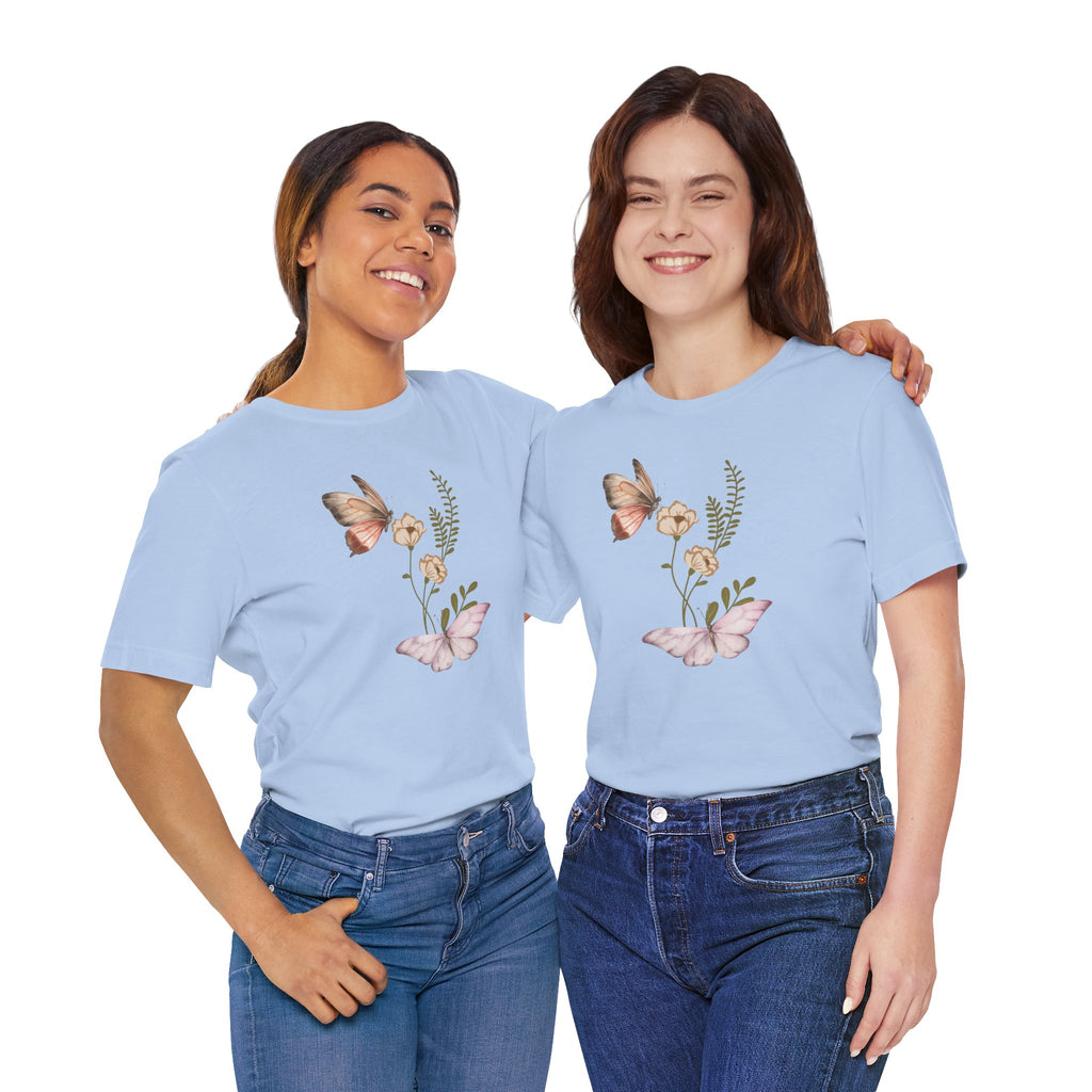 Two women wearing light blue t-shirts with floral and butterfly designs on a white background.