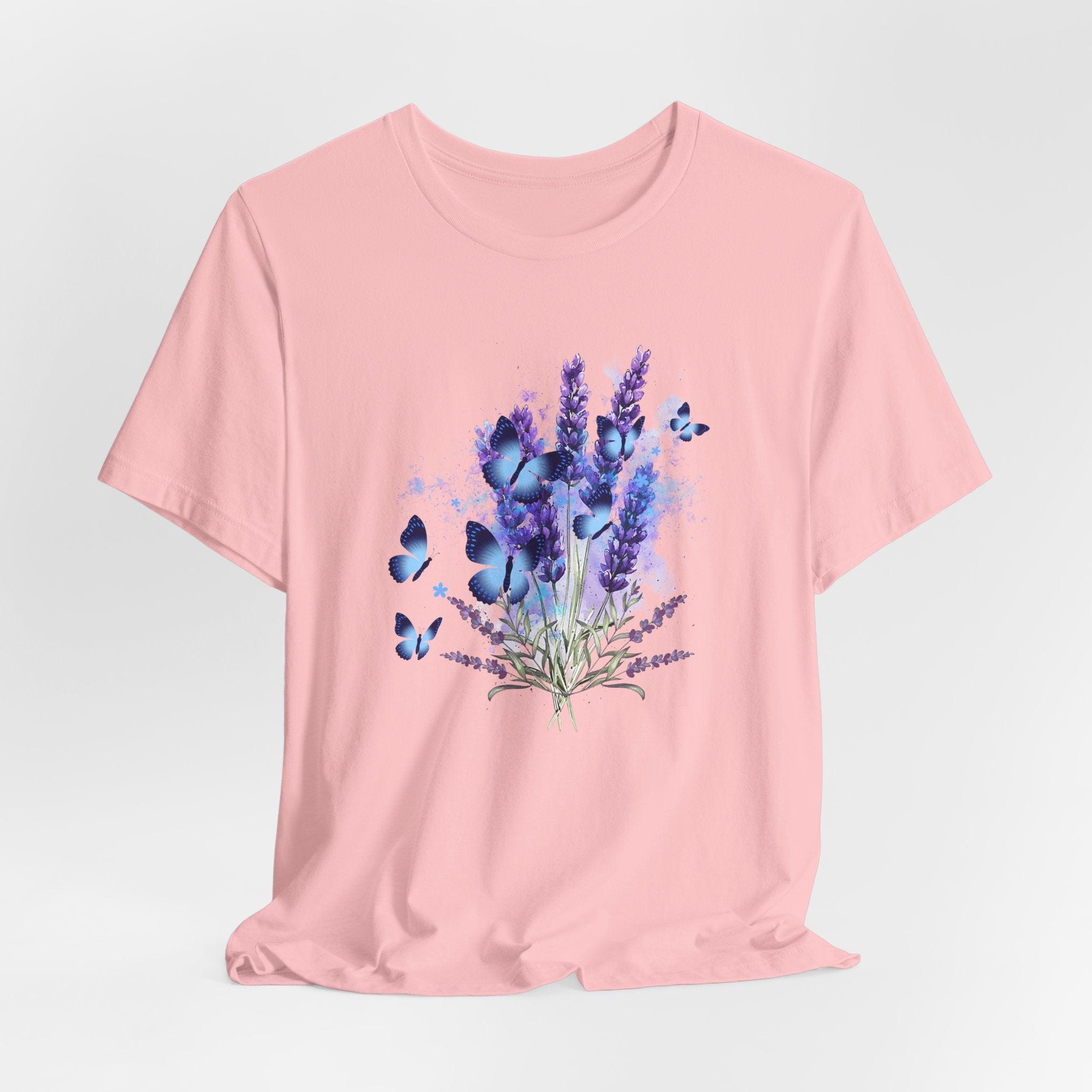 Pink t-shirt with a design of lavender flowers and butterflies on a light gray background