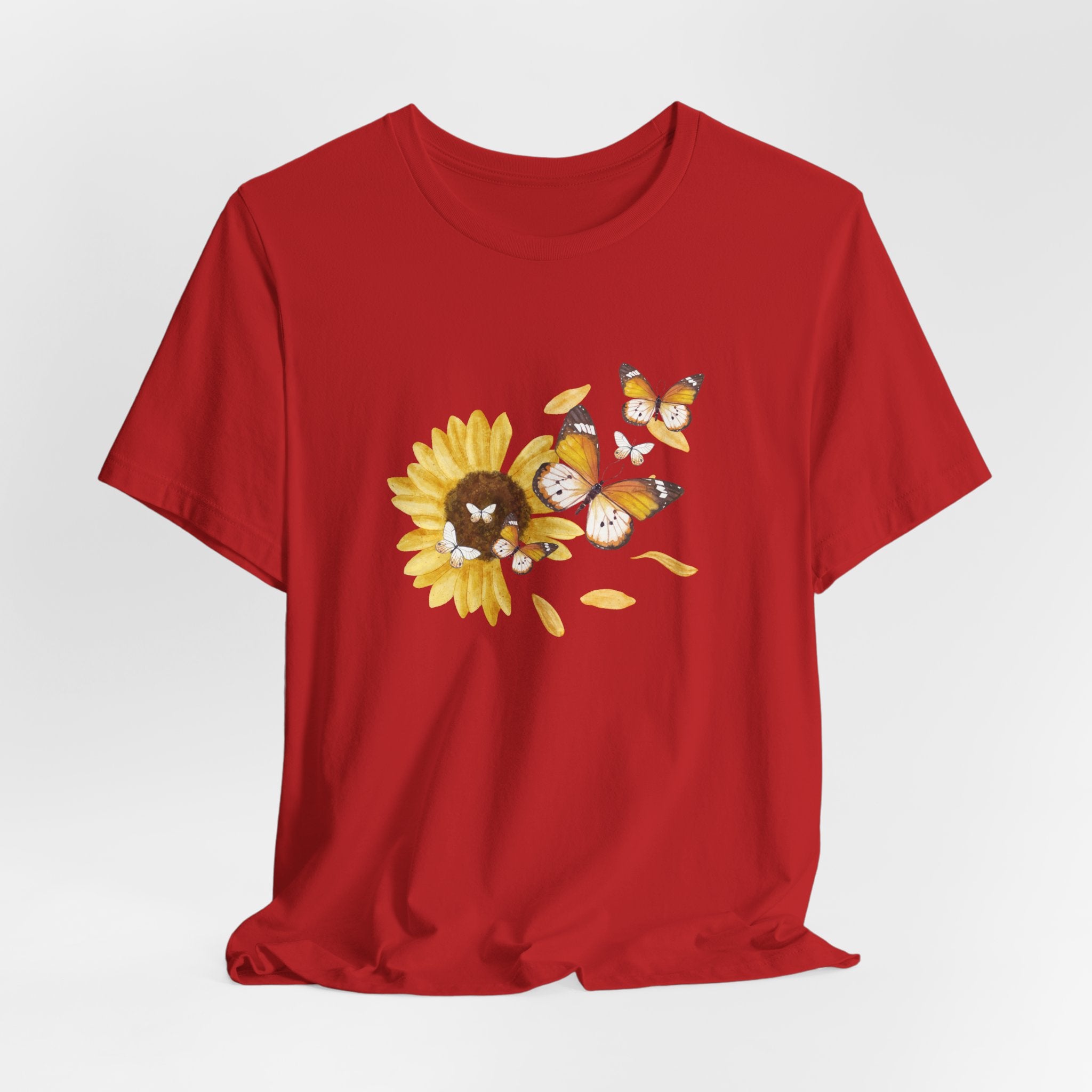 Red t-shirt with a sunflower design featuring cartoon characters on a white background