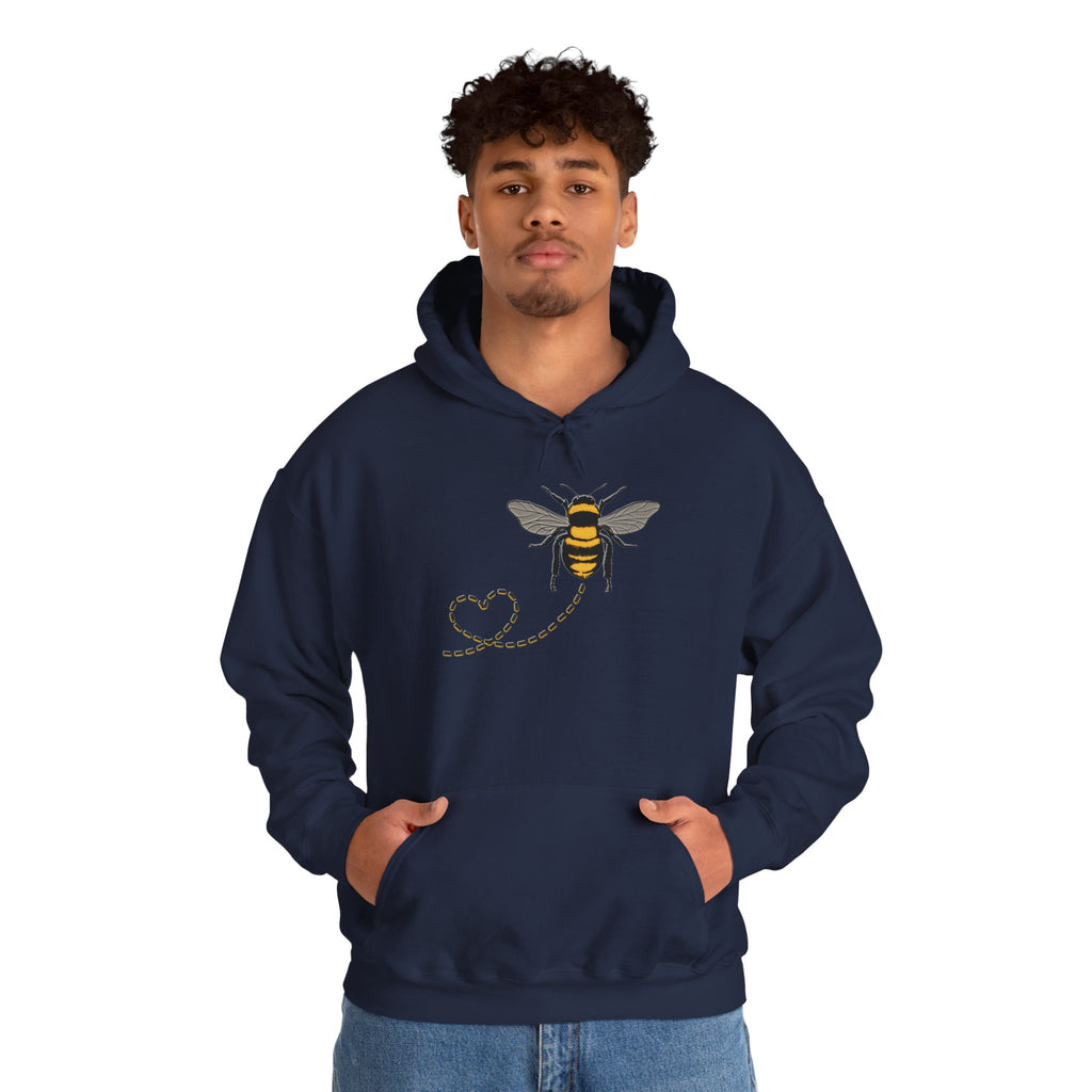 Person wearing a navy hoodie with a bee design on a white background