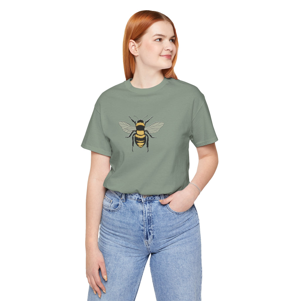 Person wearing a green t-shirt with a bee design on a white background