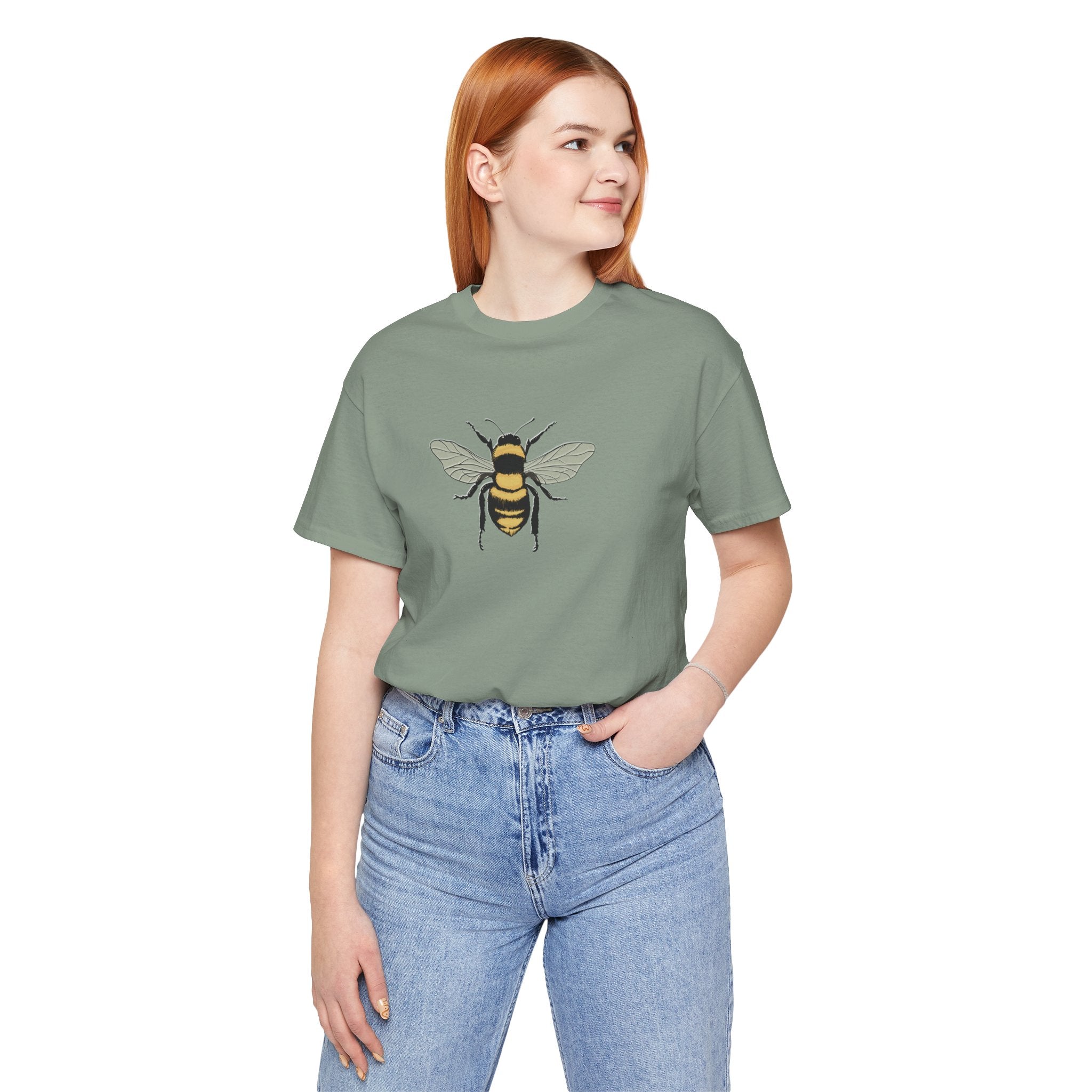 Person wearing a green t-shirt with a bee design on a white background