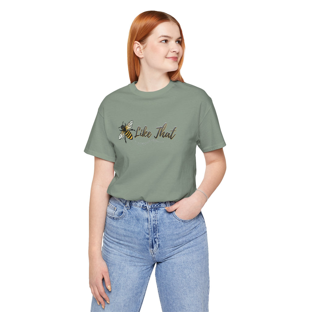 Person wearing a green t-shirt with text and a bee graphic on a white background