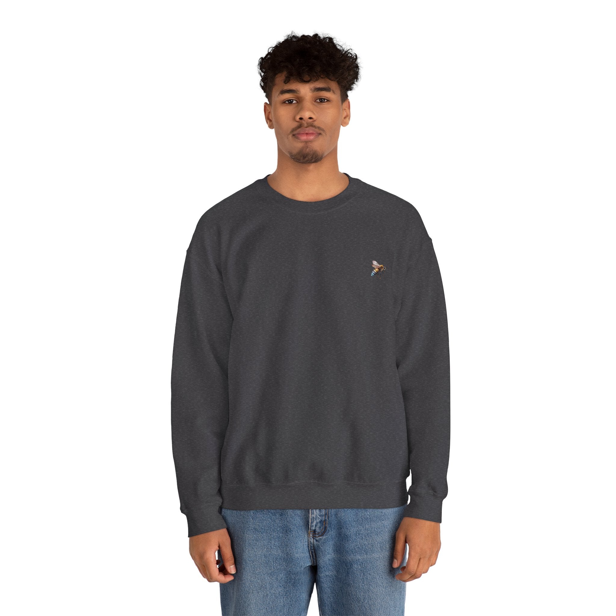 Person wearing a dark gray sweatshirt with a small bee logo on a white background