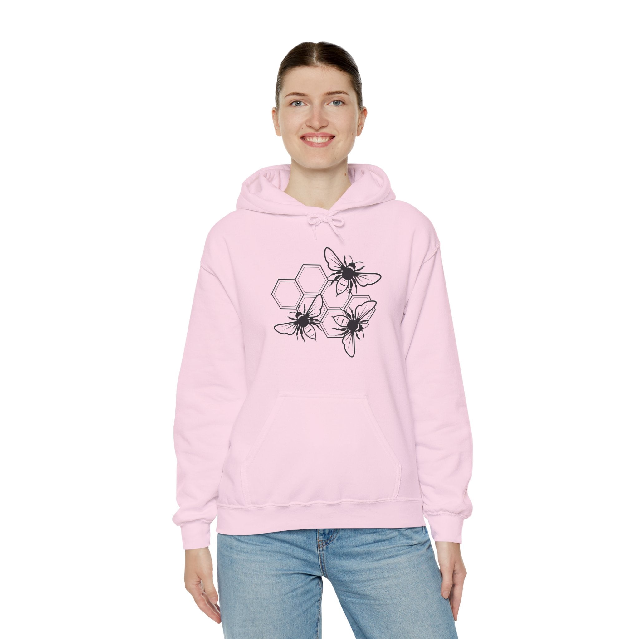 Person wearing a pink hoodie with a bee design on a white background