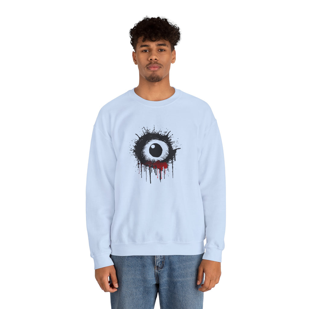 Person wearing a light blue sweatshirt with a black and white eye design on a white background