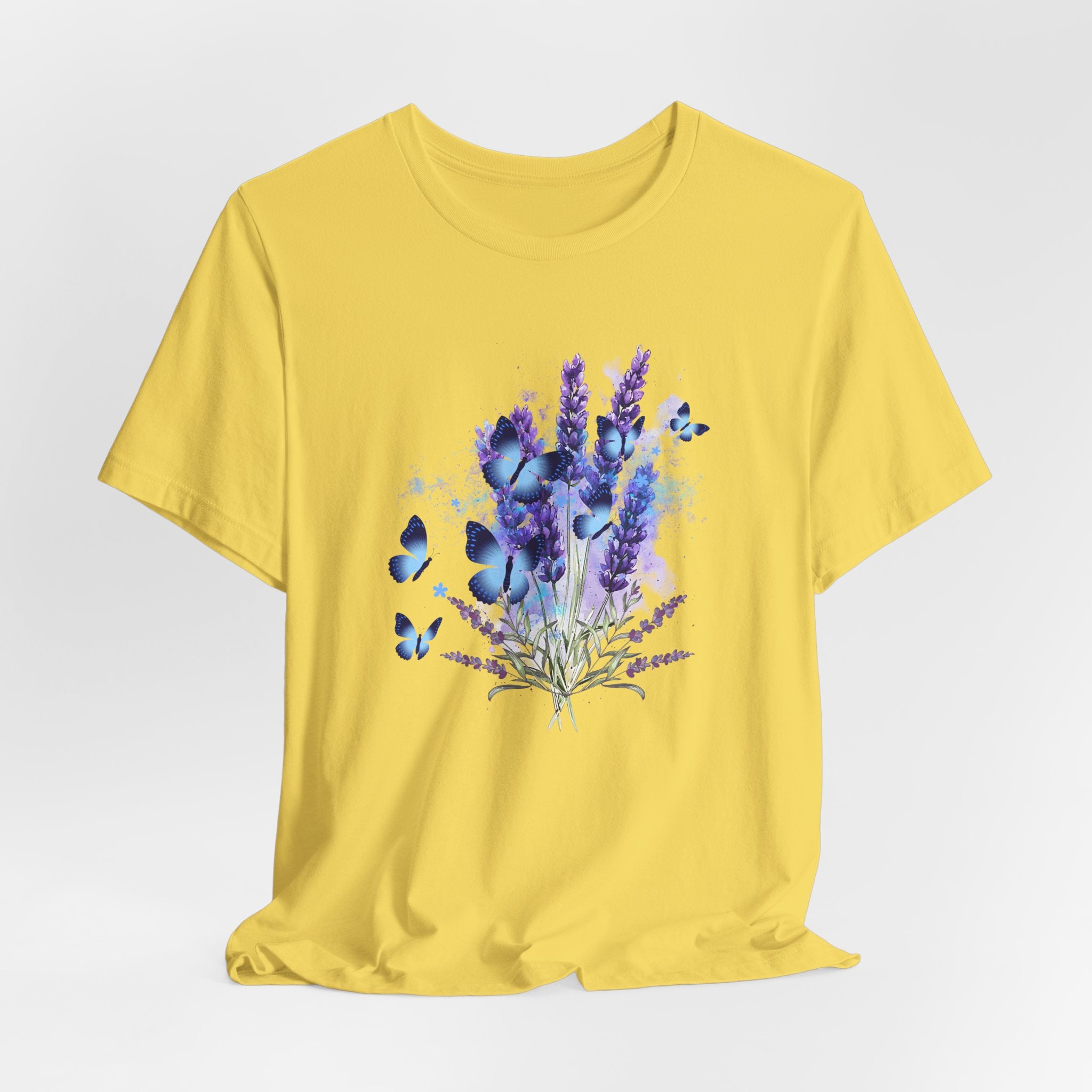 Yellow t-shirt with a floral design featuring purple flowers and blue butterflies on a white background.