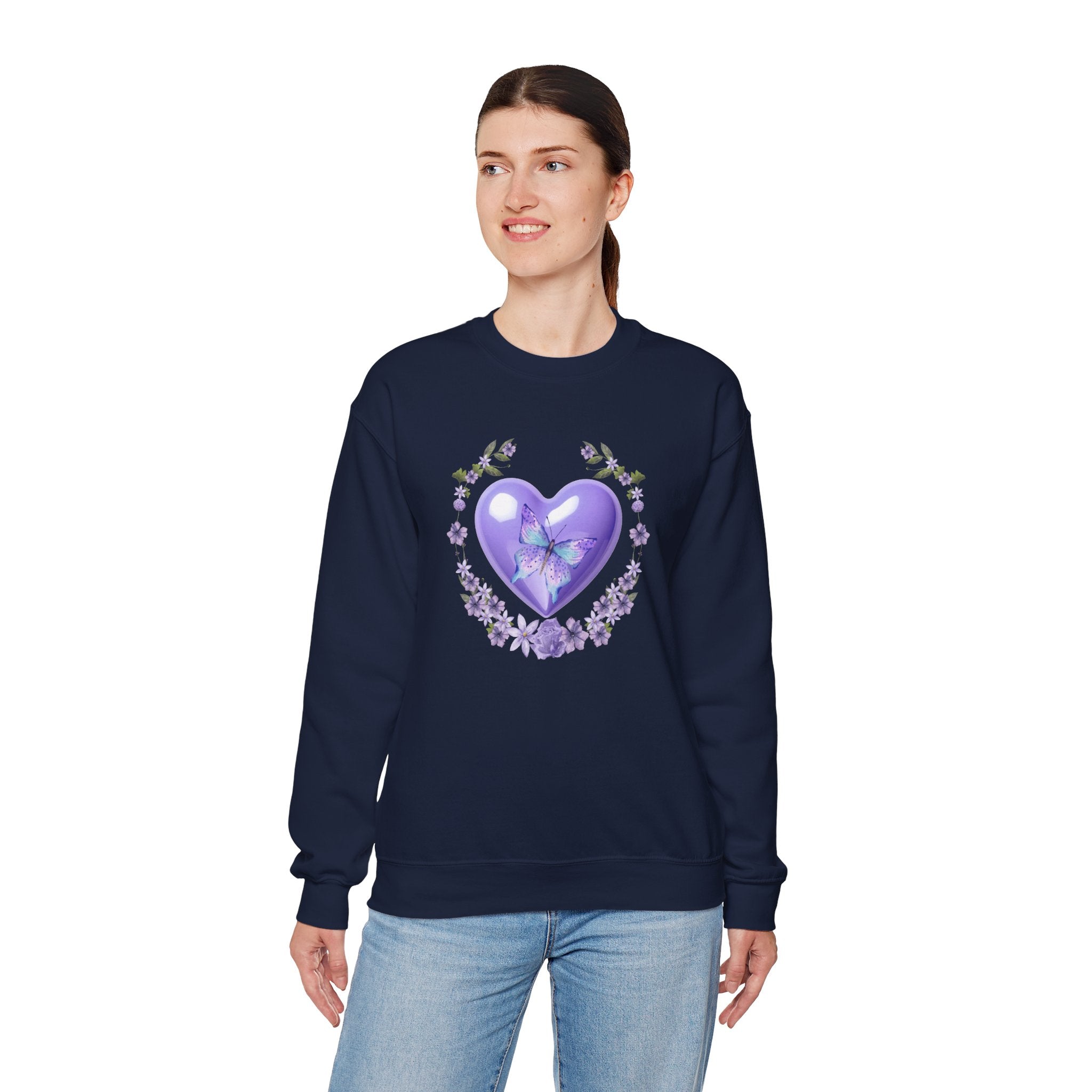 Person wearing a navy sweatshirt with a purple heart design on a white background