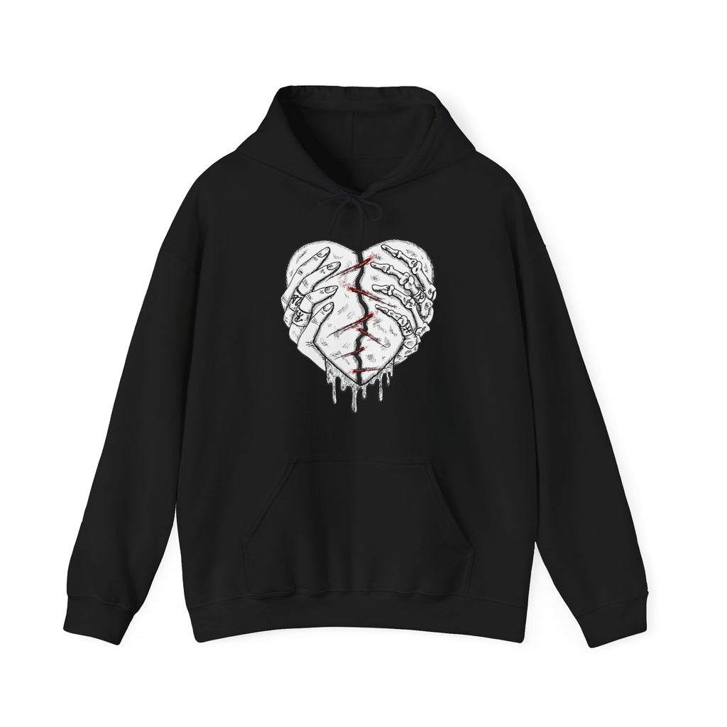 Black hoodie with a graphic design of hands holding a heart on a white background