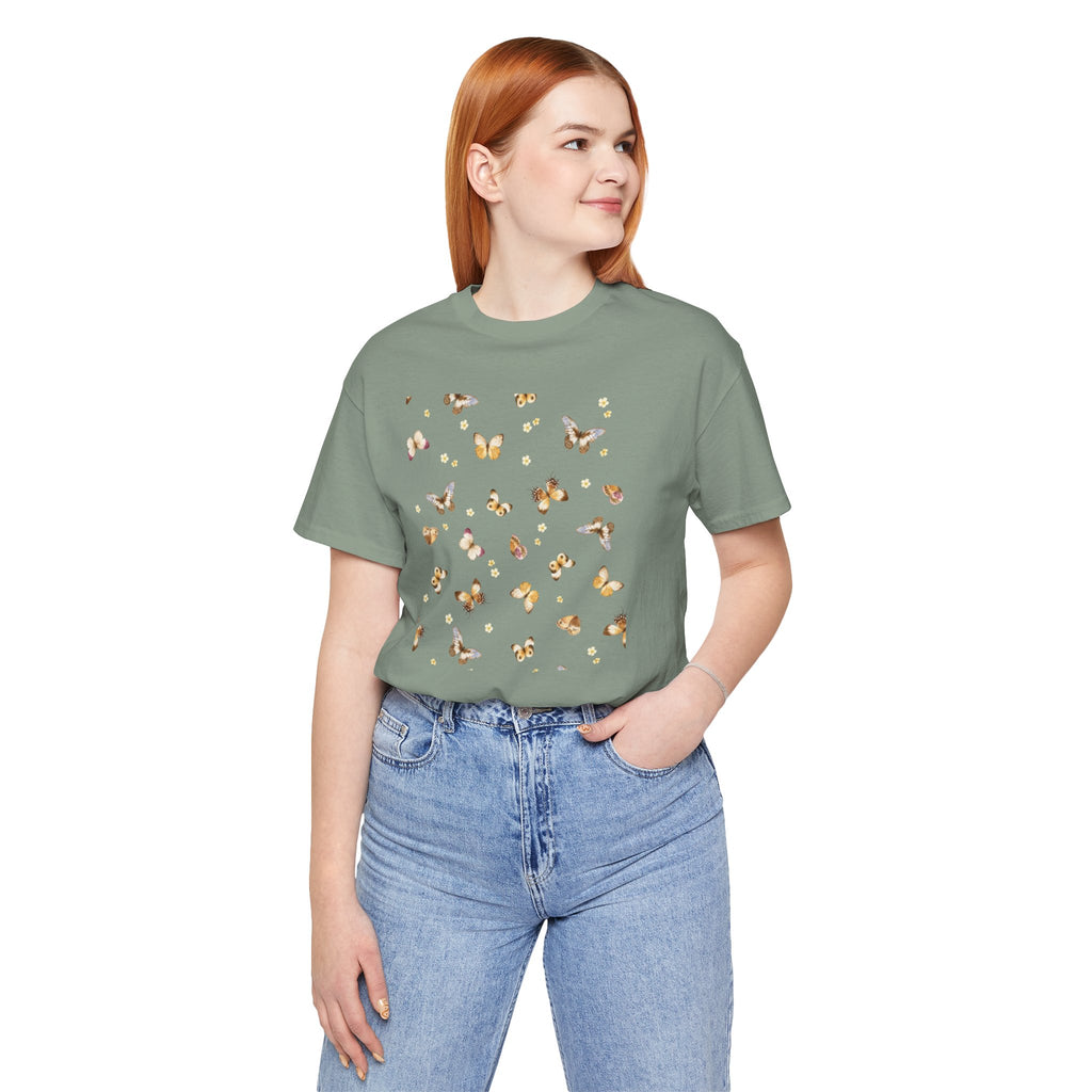 Person wearing a green t-shirt with a pattern and blue jeans on a white background