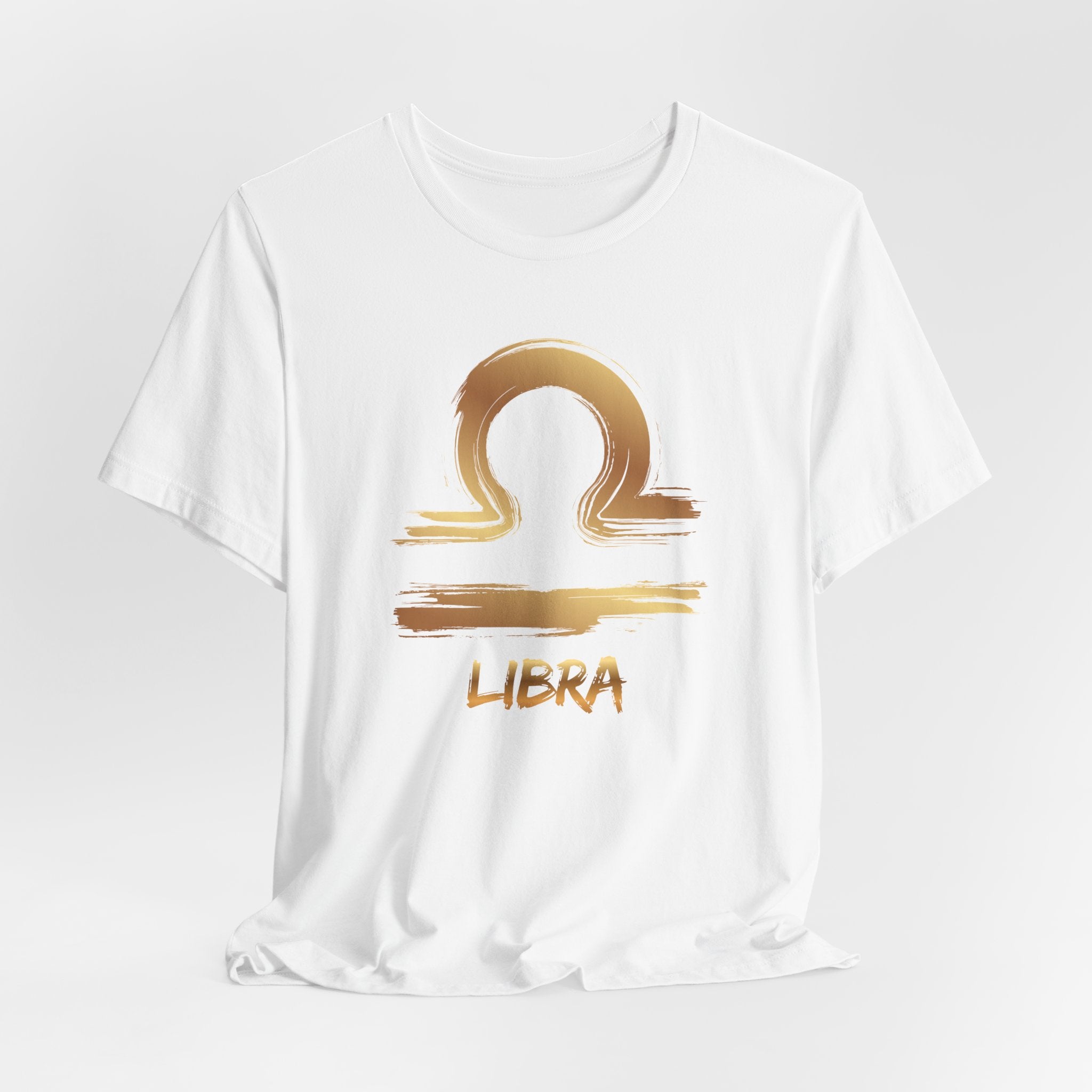 White t-shirt with gold Libra zodiac symbol on a white background