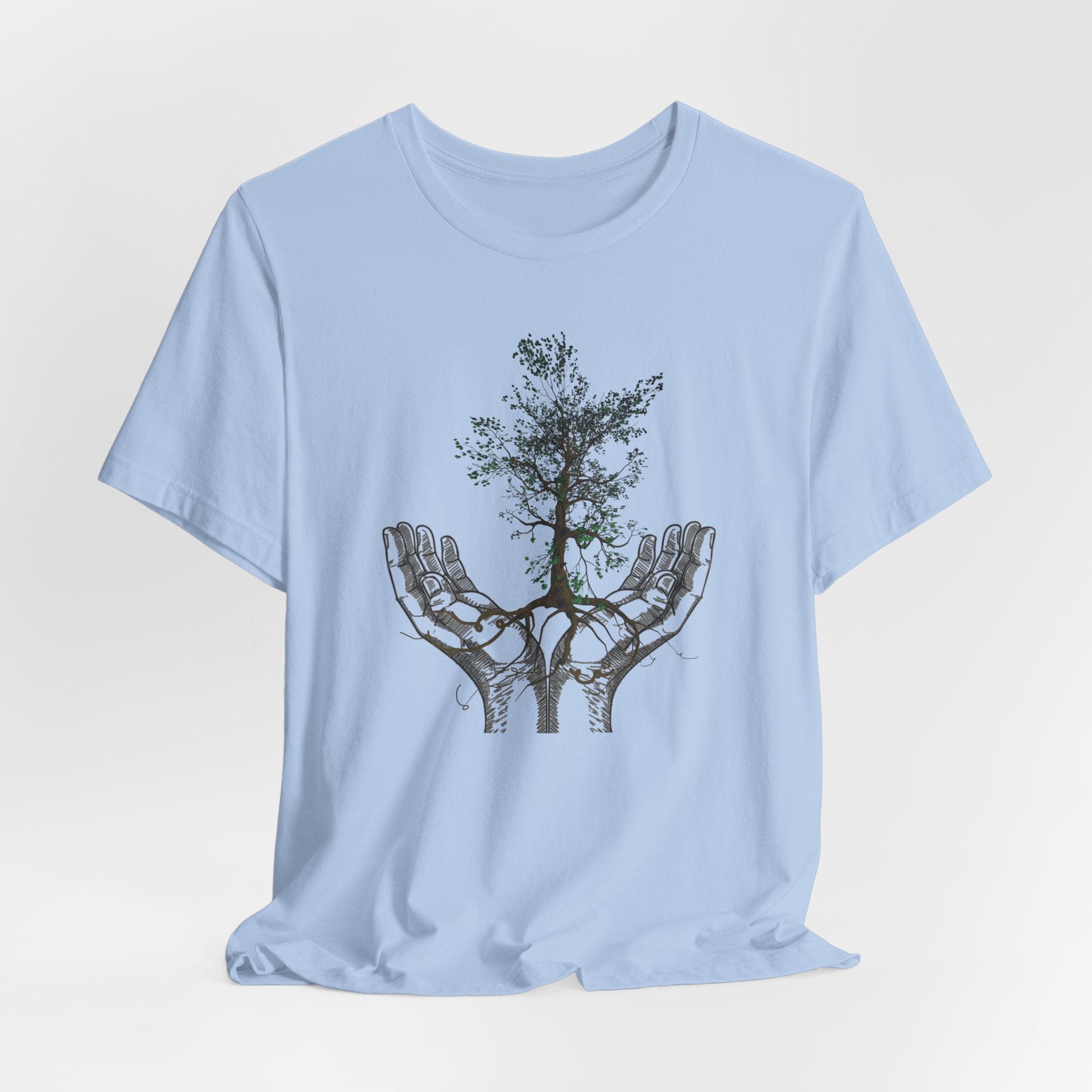 Light blue t-shirt with a graphic of hands holding a tree on a white background