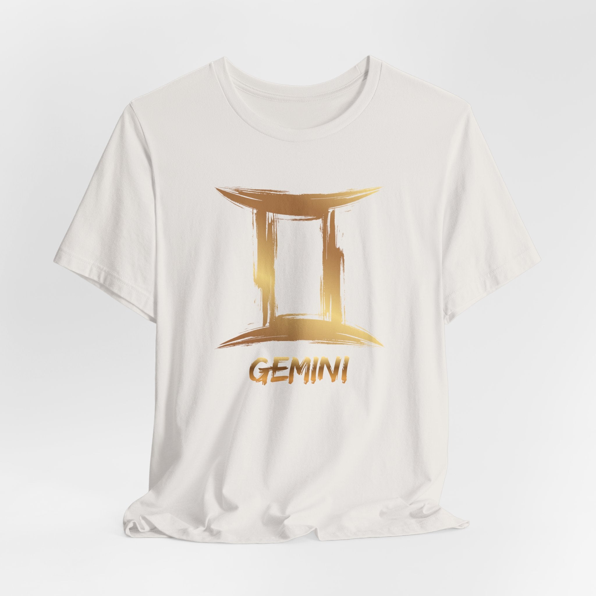 White t-shirt with gold Gemini zodiac sign design on a white background