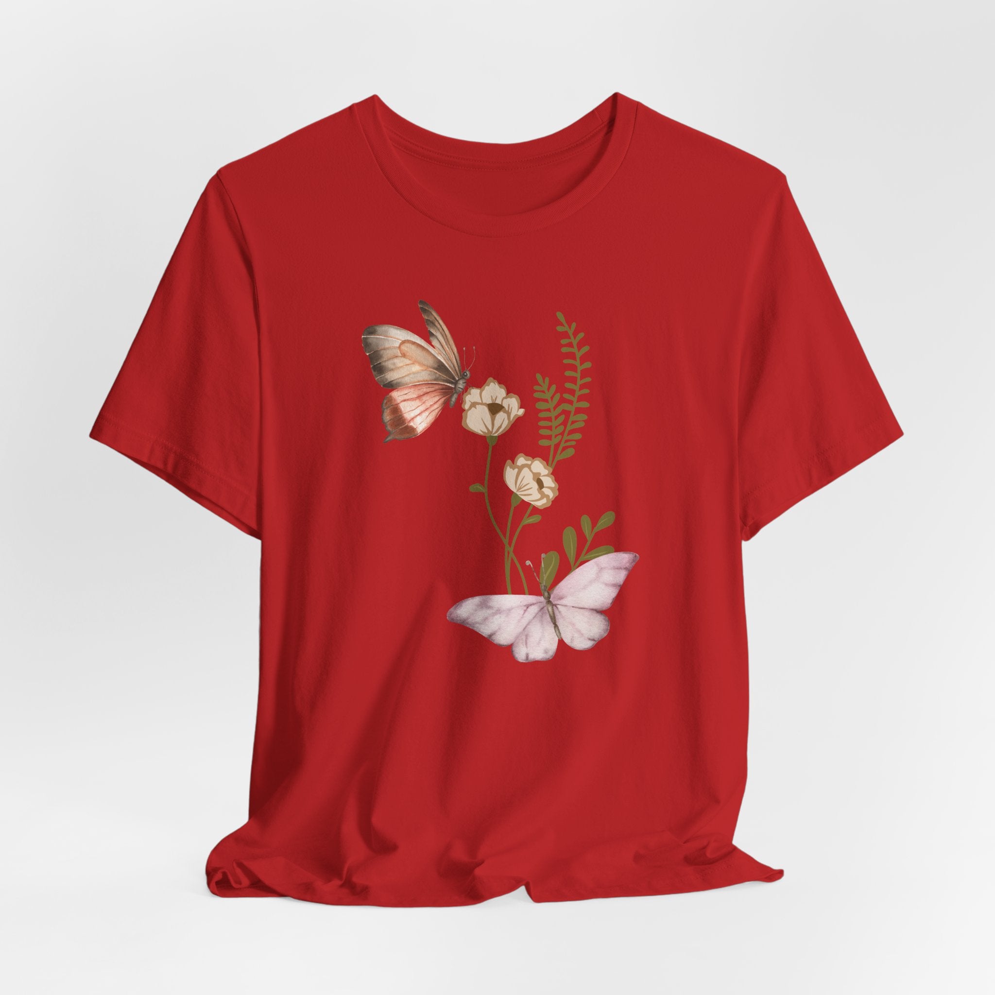 Red t-shirt with butterfly and floral design on a white background