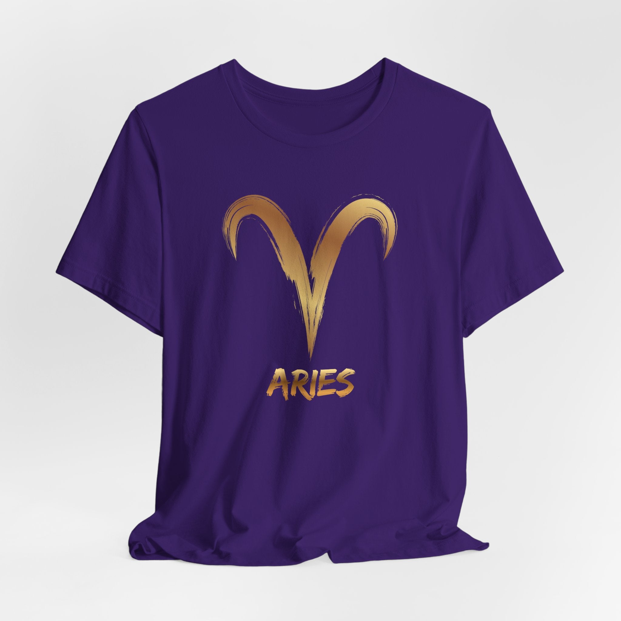 Purple t-shirt with gold Aries symbol and text on a white background