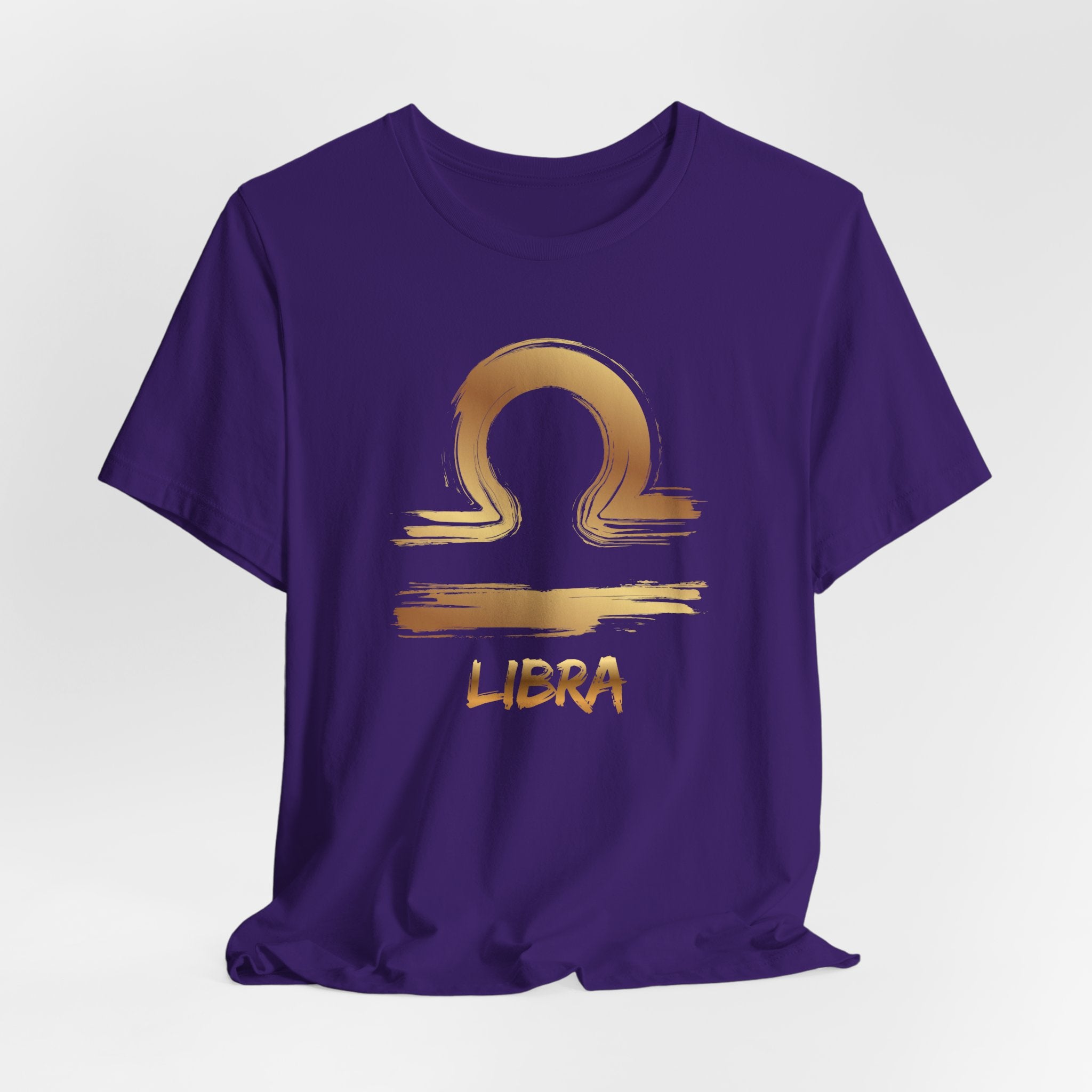 Purple t-shirt with gold Libra zodiac symbol on a white background