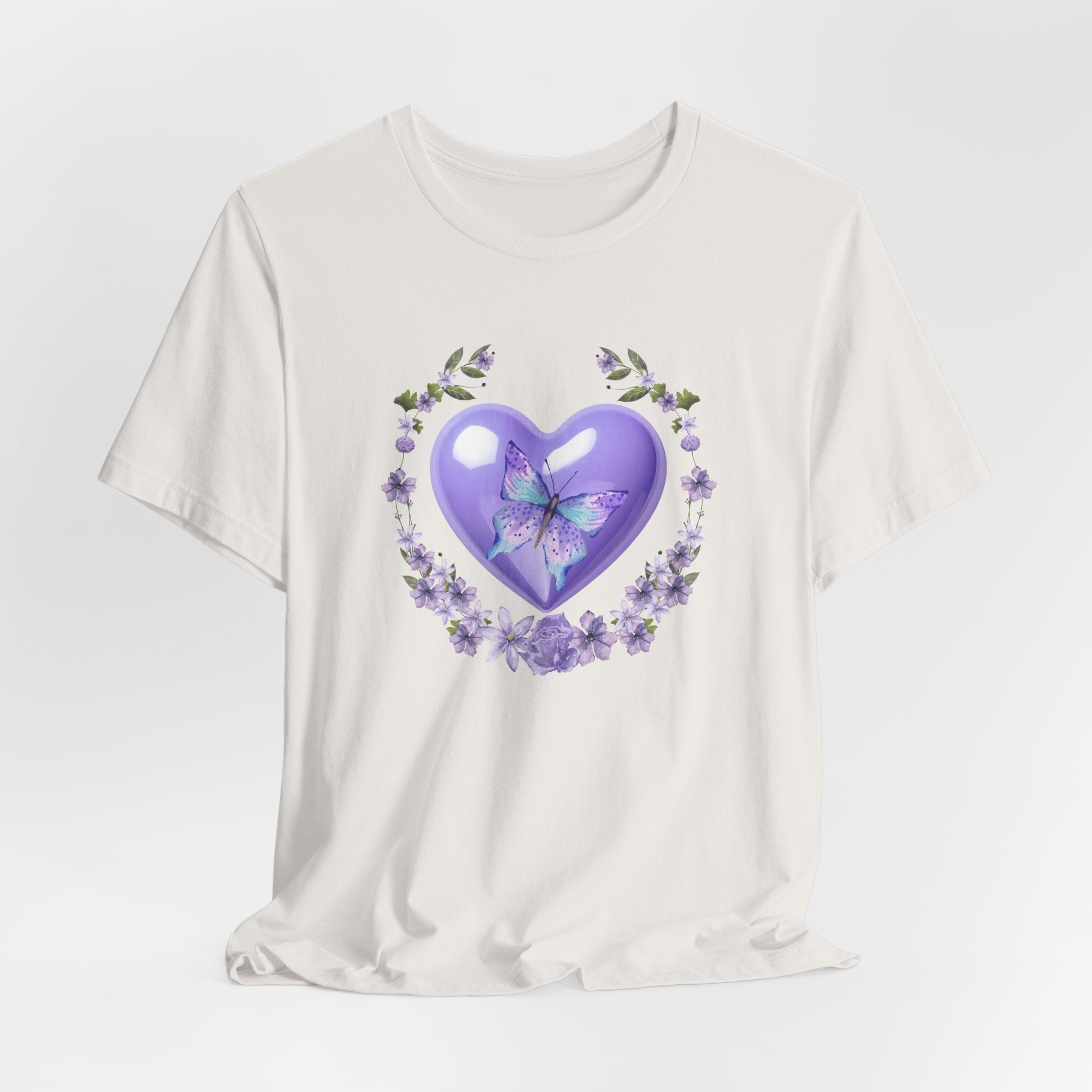 White t-shirt with a purple heart and butterfly design on a light gray background