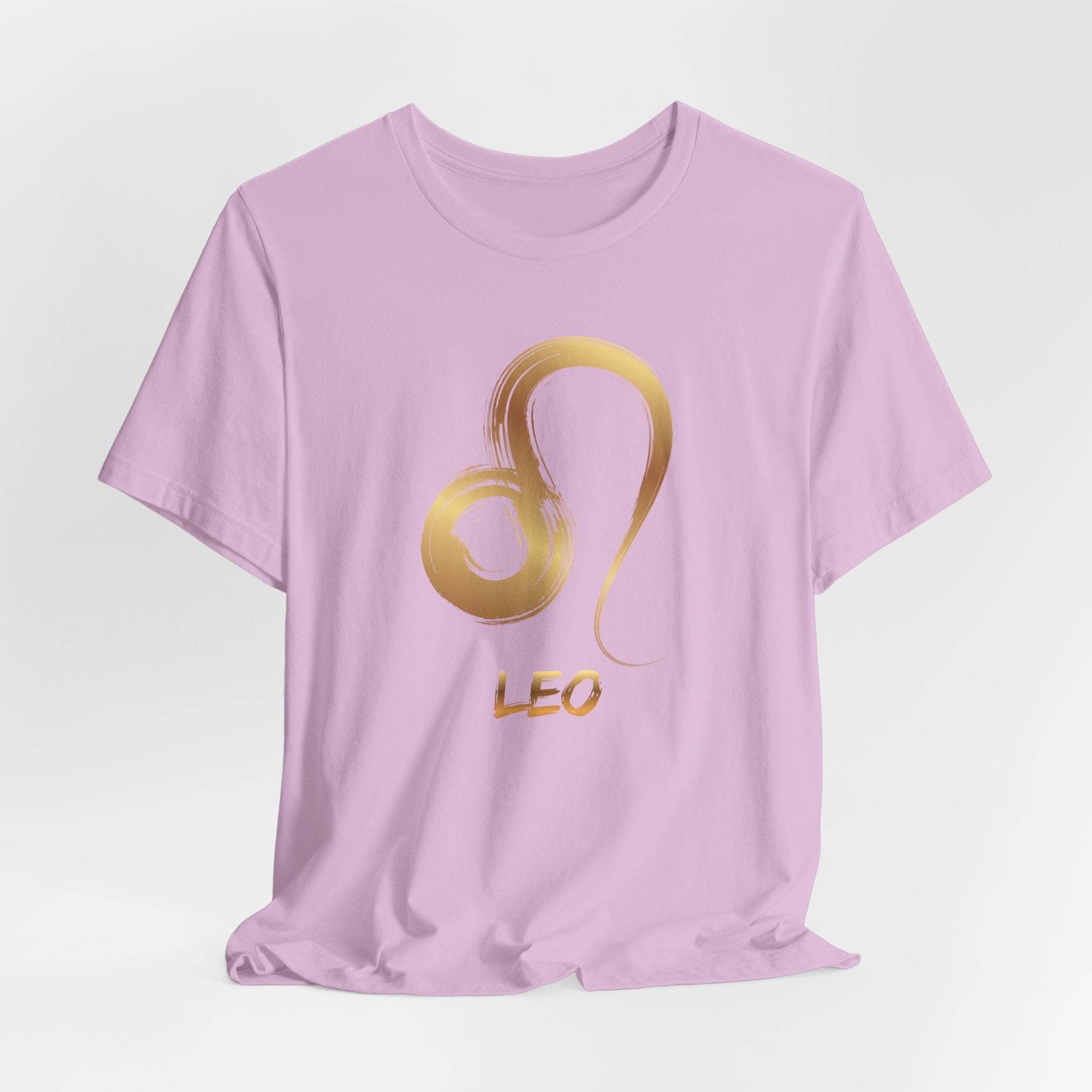 Pink t-shirt with gold Leo zodiac symbol on a light gray background