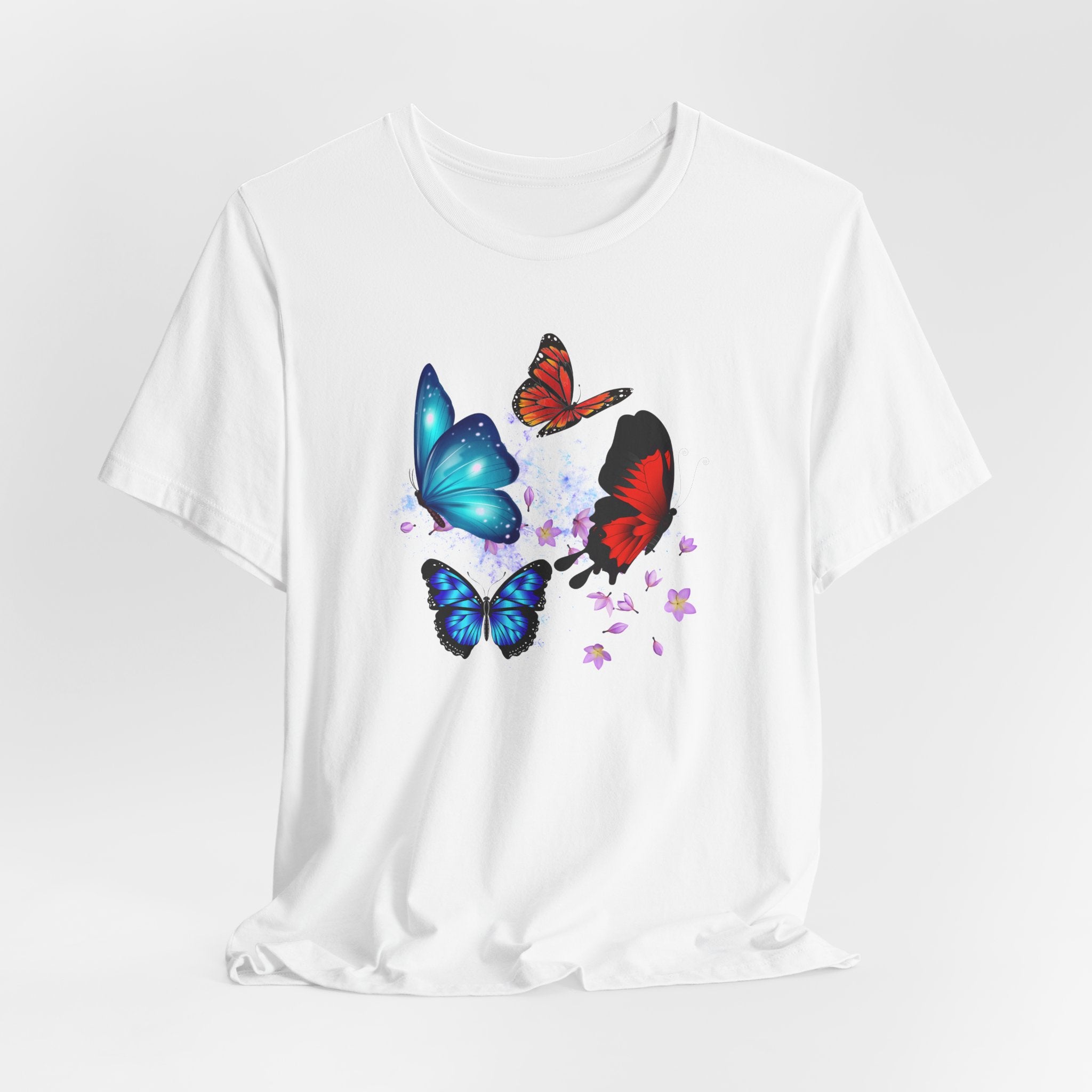 White t-shirt with colorful butterfly designs on a white background