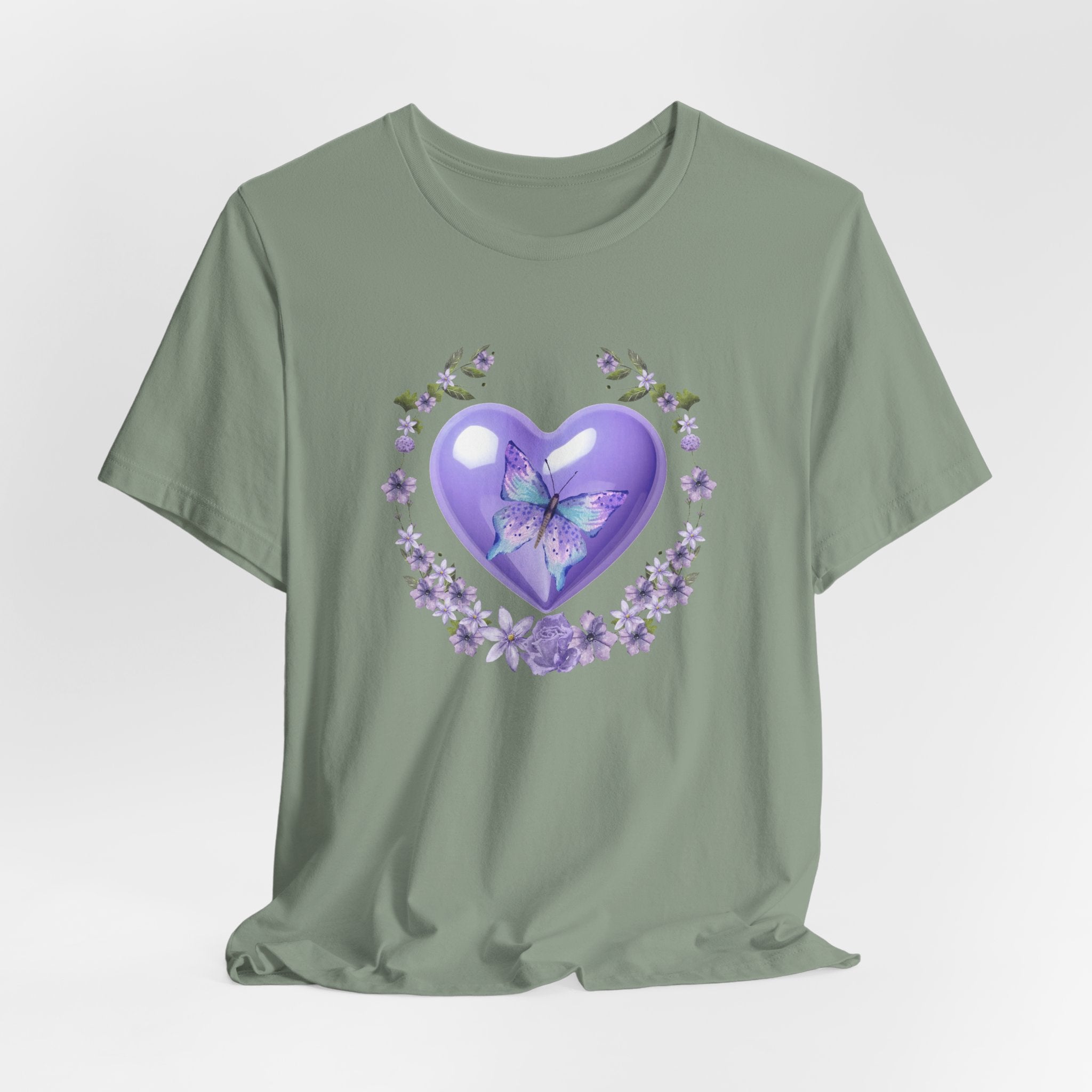 Green t-shirt with a purple heart and butterfly design on a light gray background