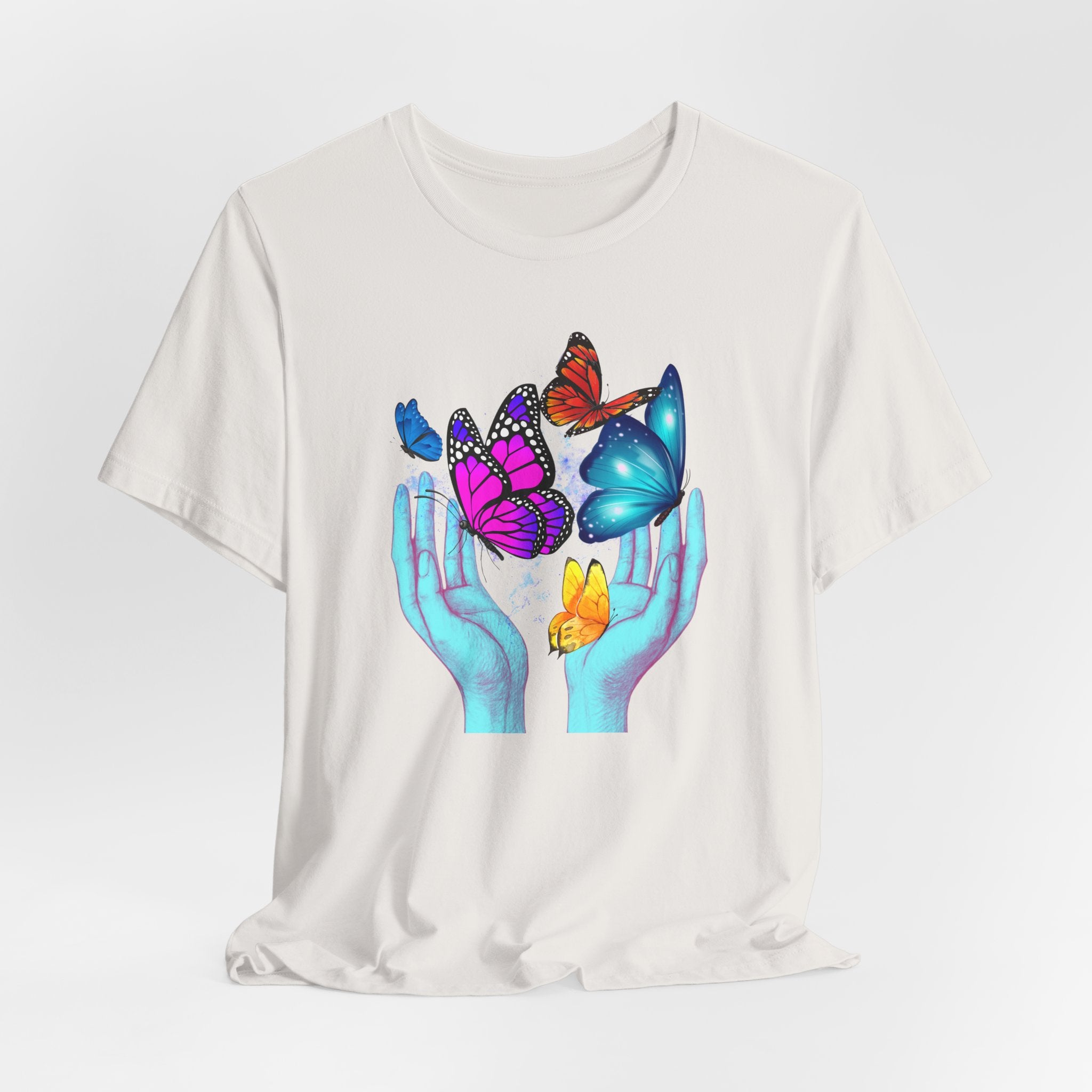 White t-shirt with colorful butterfly design on a white background