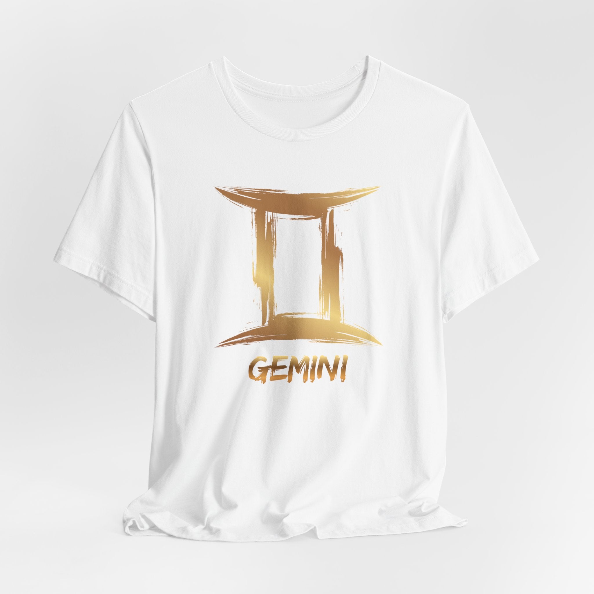 White t-shirt with gold Gemini zodiac sign design on a white background