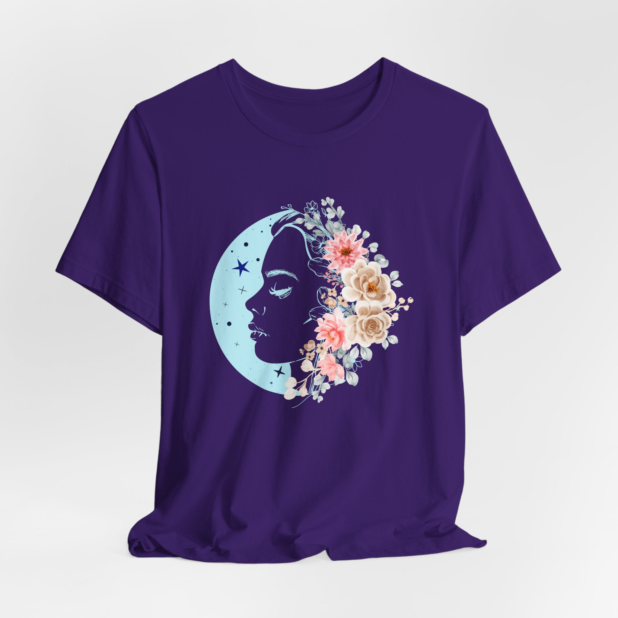 Purple t-shirt with a moon and face design featuring flowers on a white background