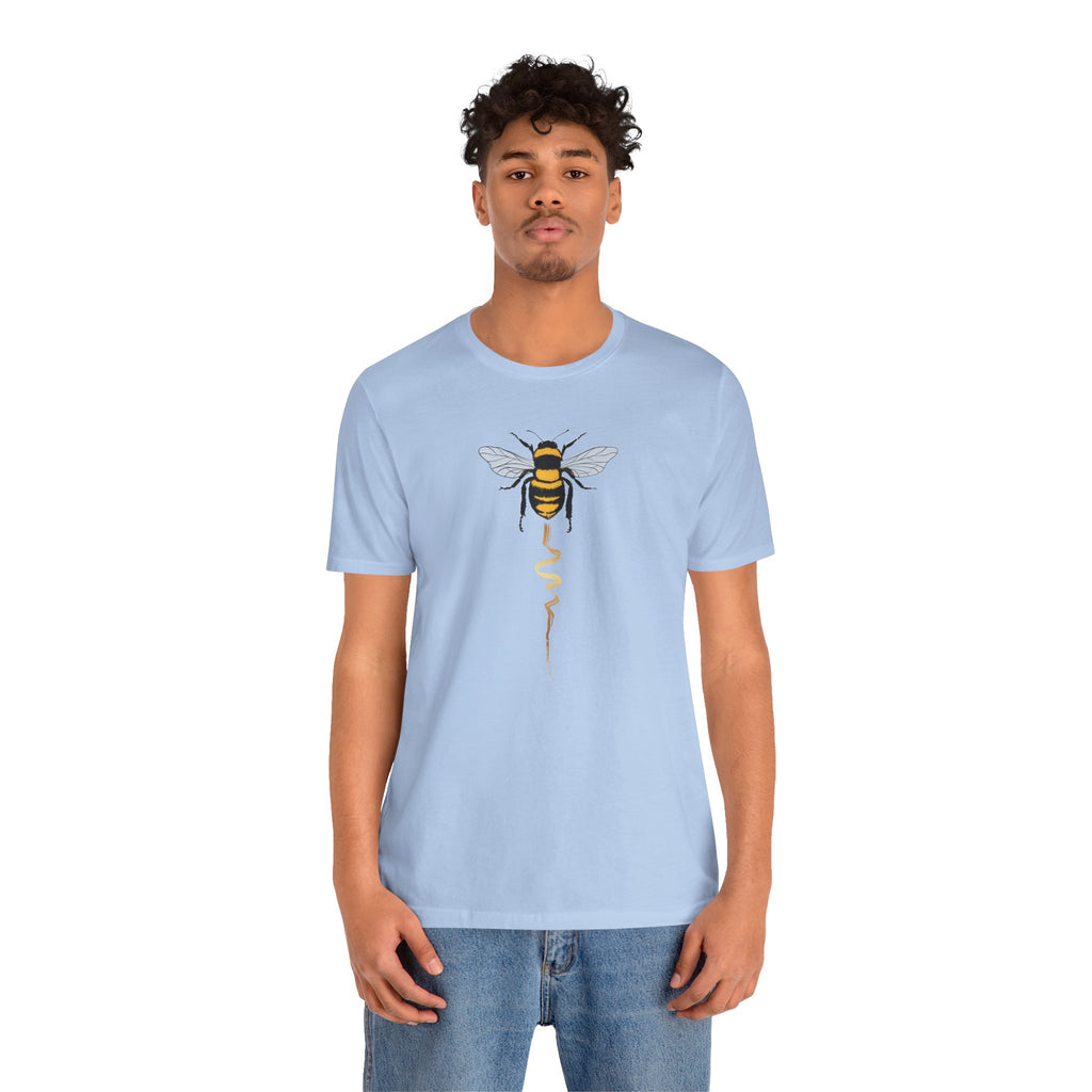 Person wearing a light blue t-shirt with a bee design on a white background