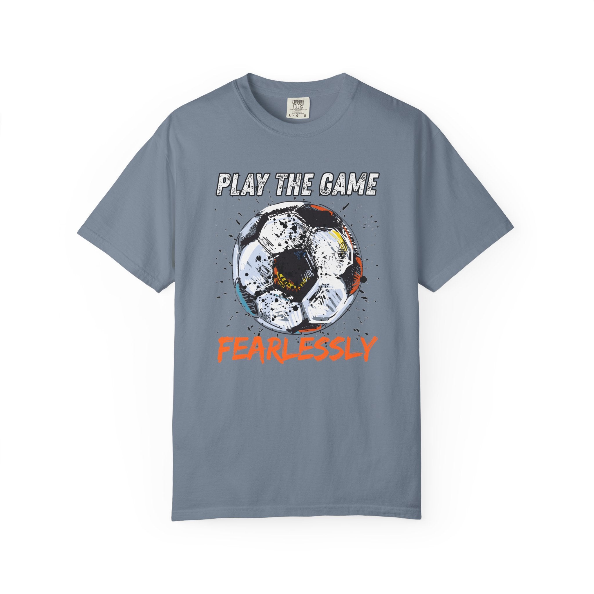 Light blue t-shirt with dirty soccer ball graphic and play the game fearlessly text on a white background