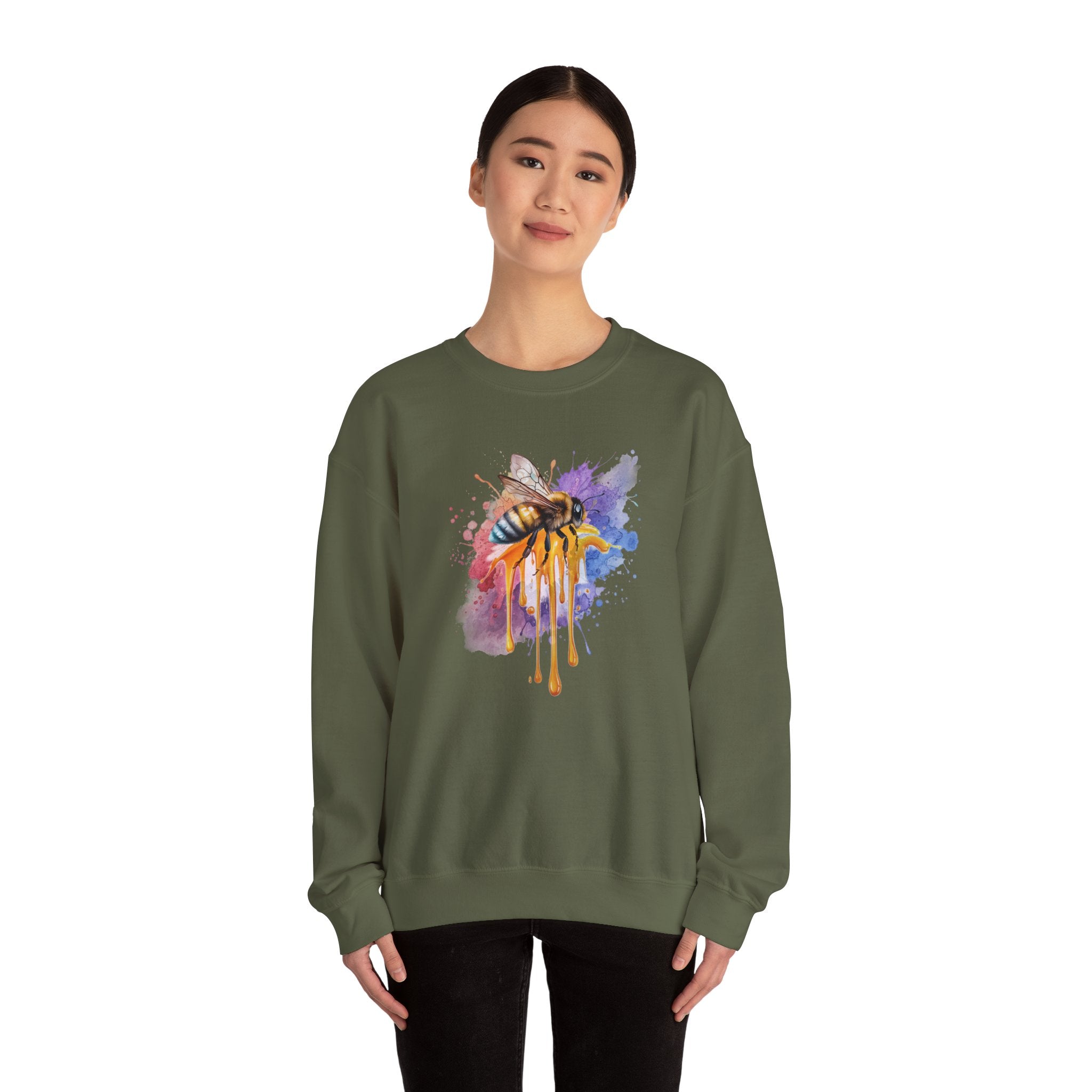 Person wearing a green sweatshirt with a colorful bee design on a white background
