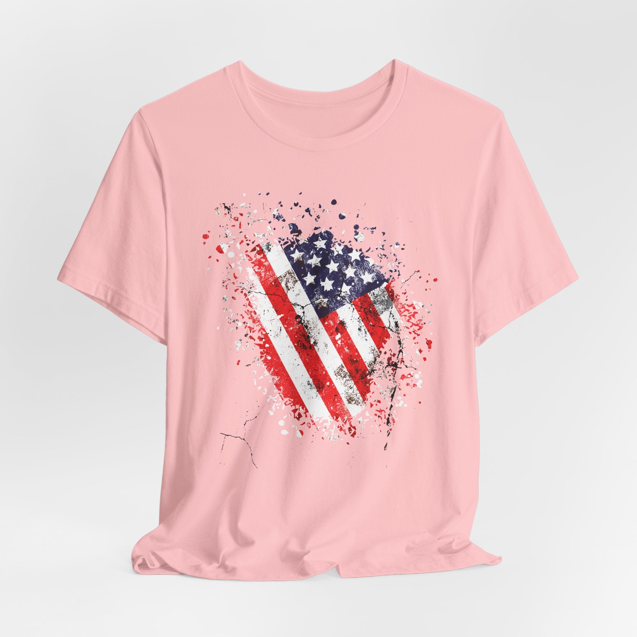 Pink t-shirt with American flag graphic on a light gray background